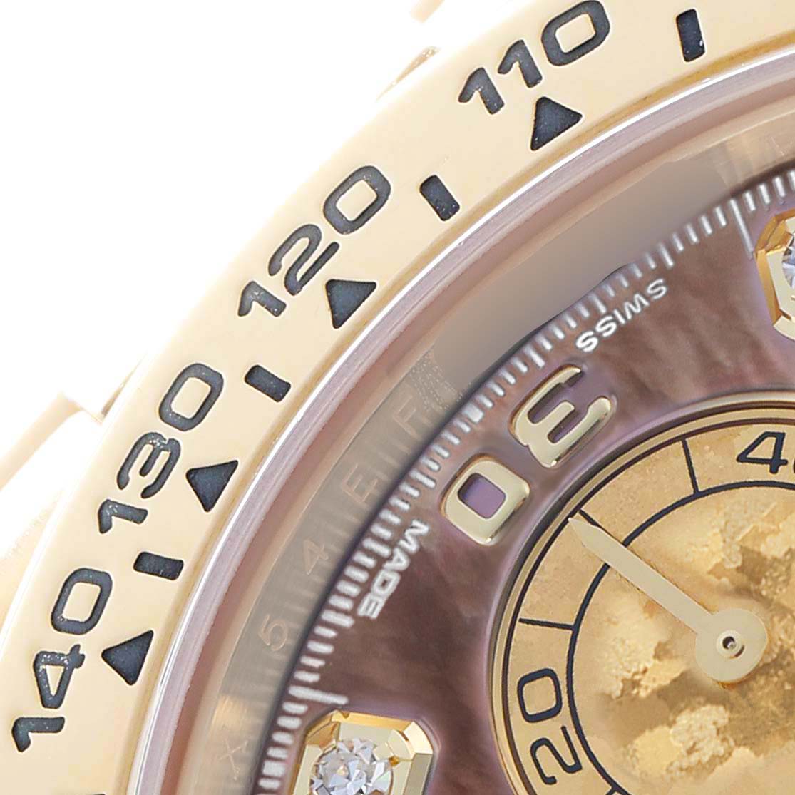 The image shows a close-up of the Rolex Daytona 116508 Men
s Yellow Gold Mother of Pearl Dial
s bezel and part of the dial, highlighting the tachymetric scale and hour markers.