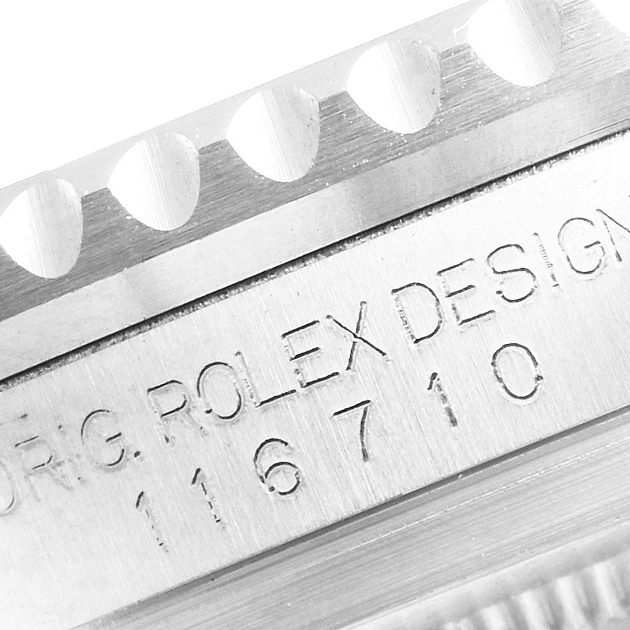 This image shows a close-up shot of the Rolex GMT-Master 116710 Men's Stainless Steel Black Dial 116710 Men's Stainless Steel Black Dial model's case with "ROLEX DESIGN" and the reference number engraved.