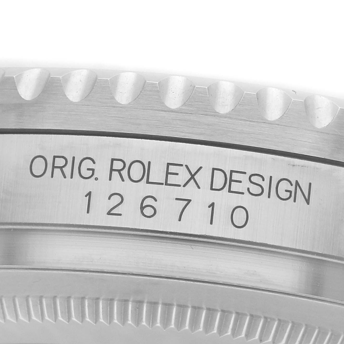 The image shows the side view of a Rolex GMT-Master 126710 Men
s Stainless Steel Black Dial model, focusing on the engraved serial number and "ORIG. ROLEX DESIGN" text.
