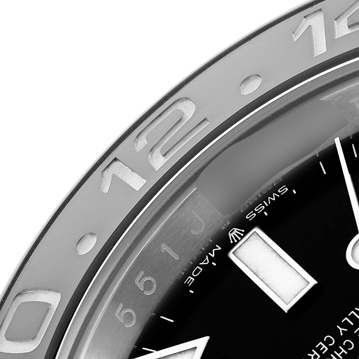 The image shows a close-up of the bezel and part of the dial of a Rolex GMT-Master 126710 Men's Stainless Steel Black Dial watch.