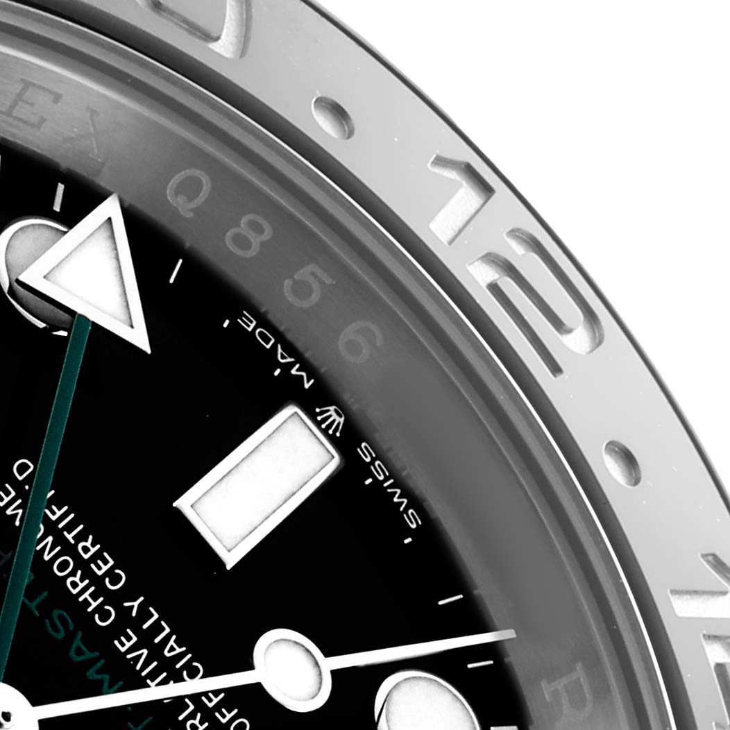 The image shows a close-up of a Rolex GMT-Master 126710 Men's Stainless Steel Black Dial watch face, highlighting the bezel, dial, and part of the GMT hand.