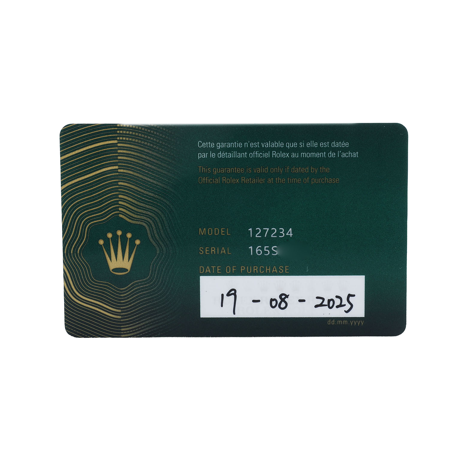 The image shows a Rolex Land-Dweller guarantee card with model and serial numbers, viewed from the front.