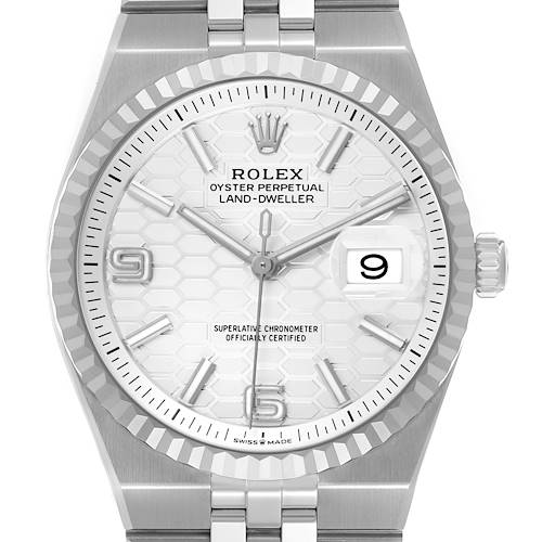 The Rolex Land-Dweller watch is shown from the front, highlighting its dial, bezel, and part of the bracelet.