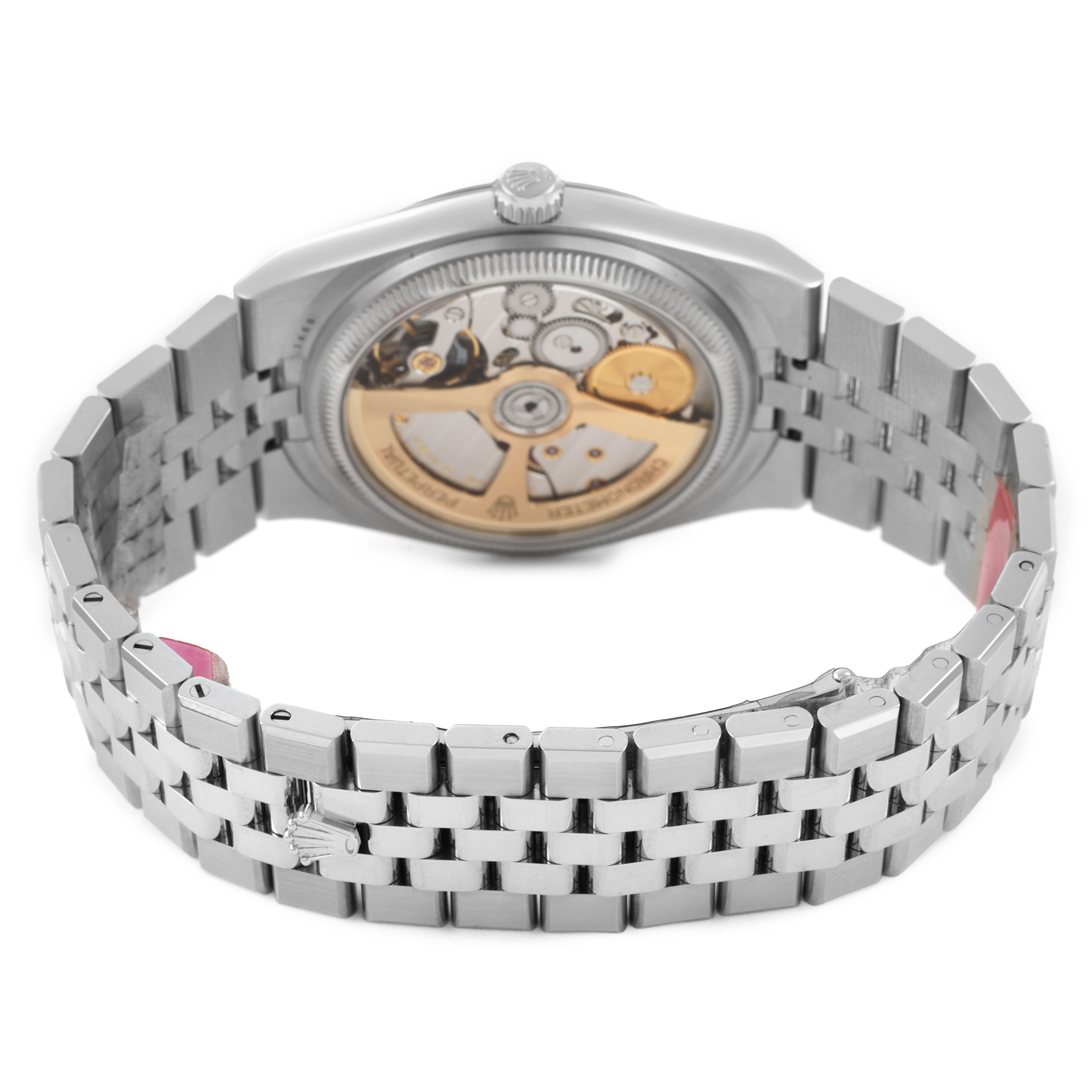The image shows the back of the Rolex Land-Dweller watch, revealing its movement and metal bracelet from a rear angle.