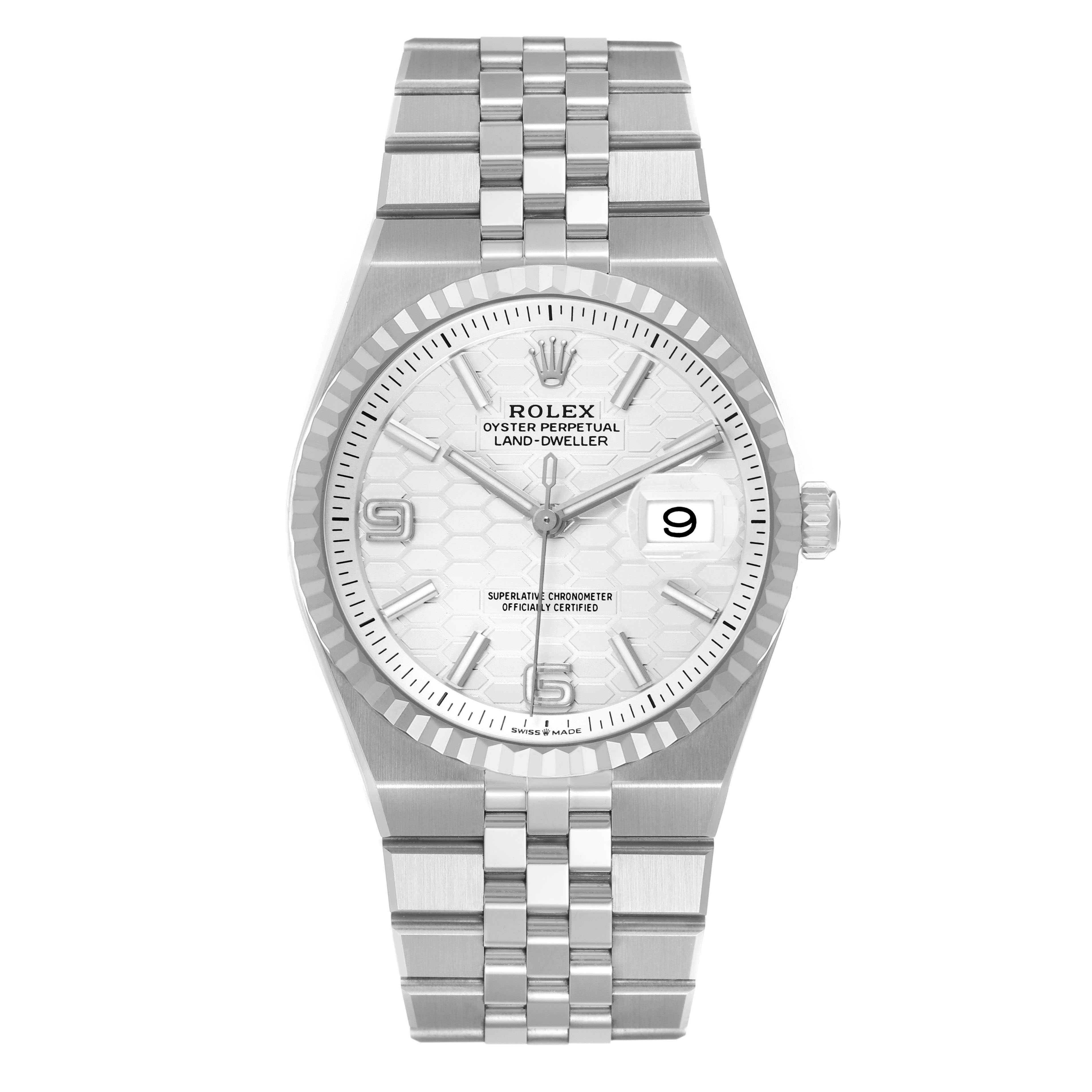 The image shows a Rolex Land-Dweller watch from a top-down angle, highlighting the face, bezel, and bracelet.