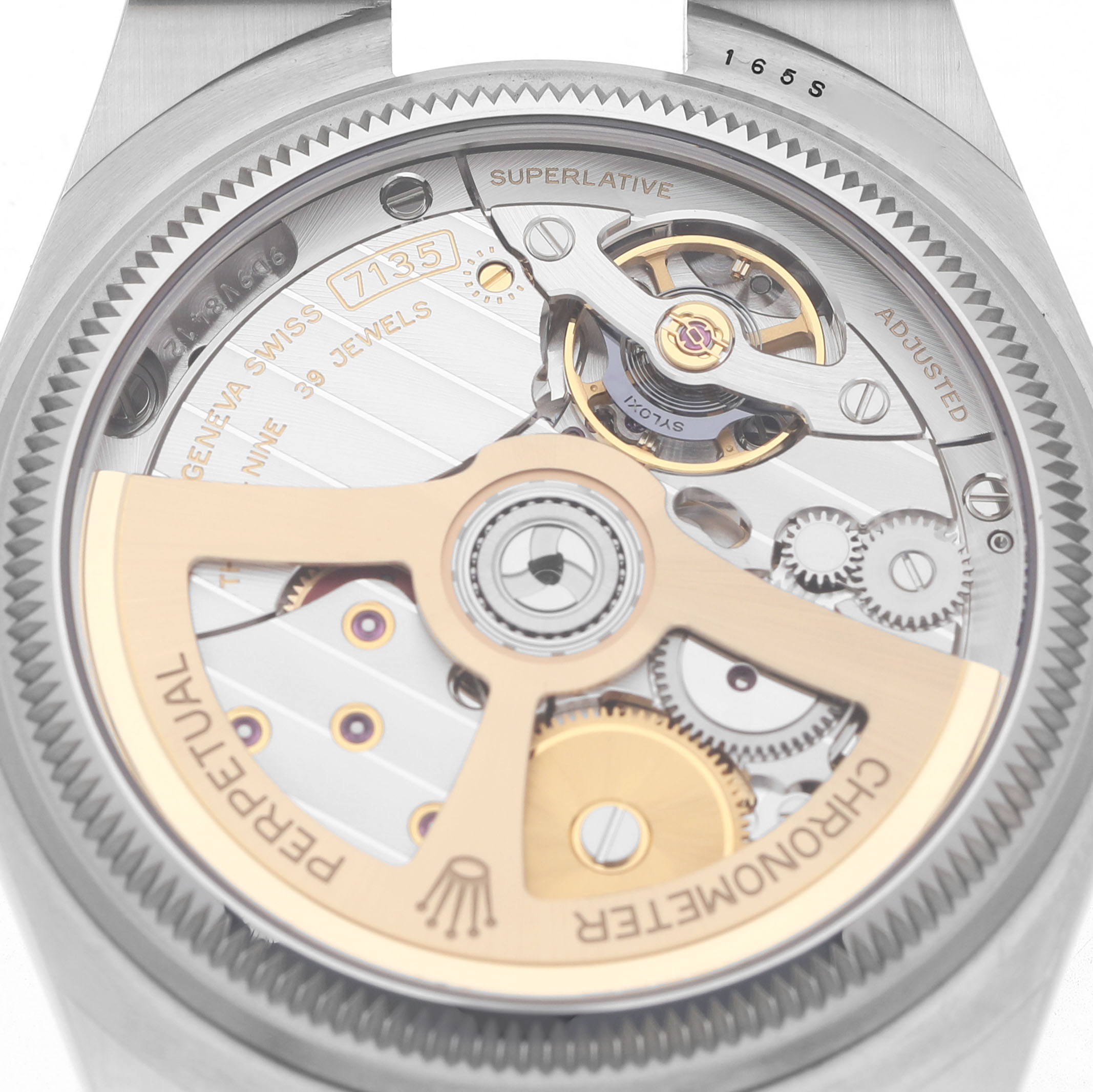The image shows the back view of a Rolex Land‑Dweller 127234 Men's Stainless Steel White Dial, highlighting its intricate movement and rotor.
