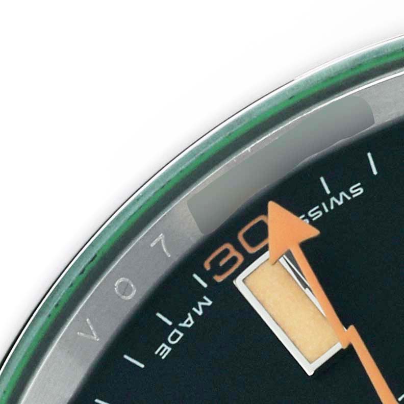 This close-up of the Rolex Milgauss 116400 Men's Stainless Steel Black Dial 116400 Men's Stainless Steel Black Dial watch shows part of the dial, including hour markers, minute hand, and a section of the bezel.
