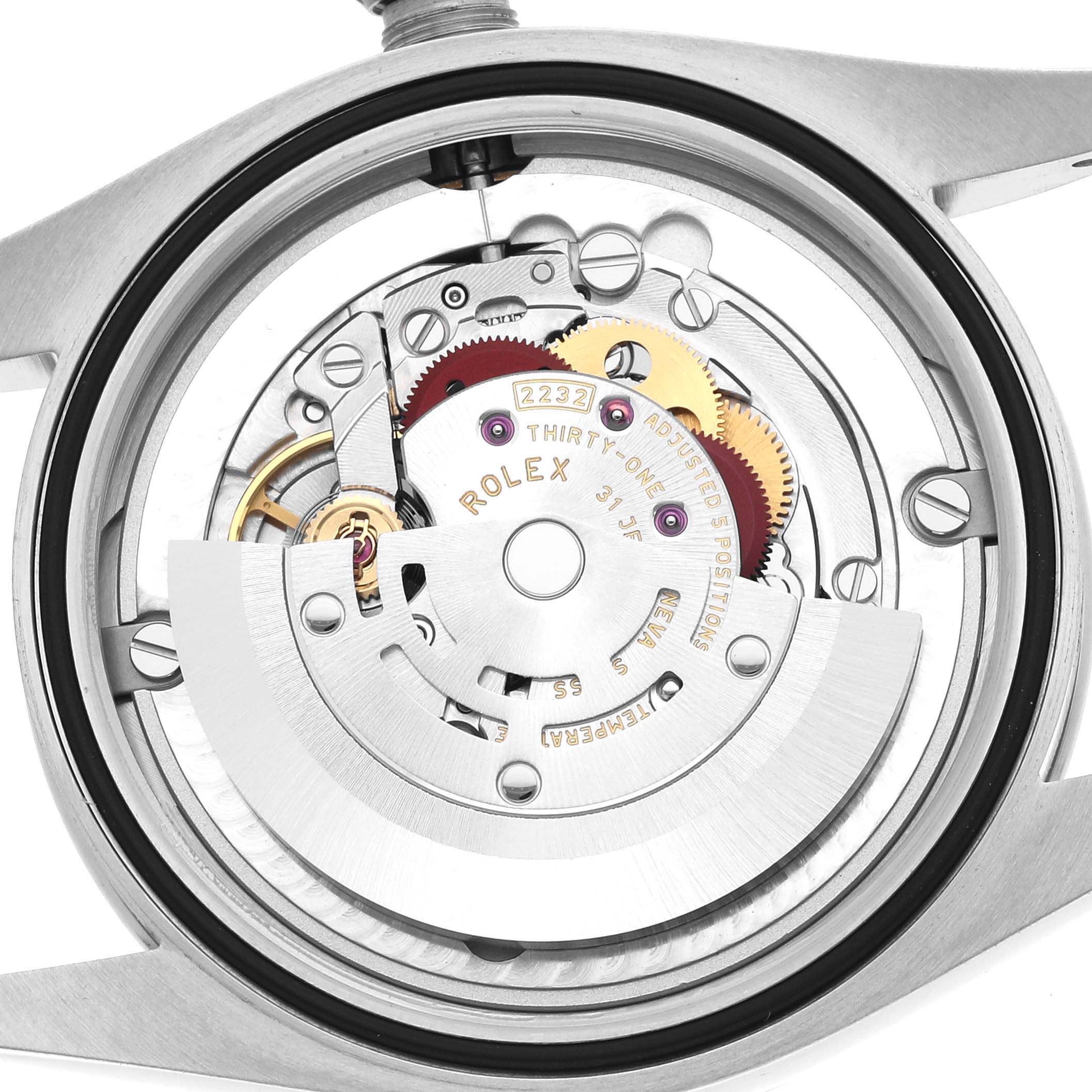 This image shows the movement and internal mechanism of a Rolex Oyster Perpetual 124200 Men
s Stainless Steel Beige Dial watch from the back angle.