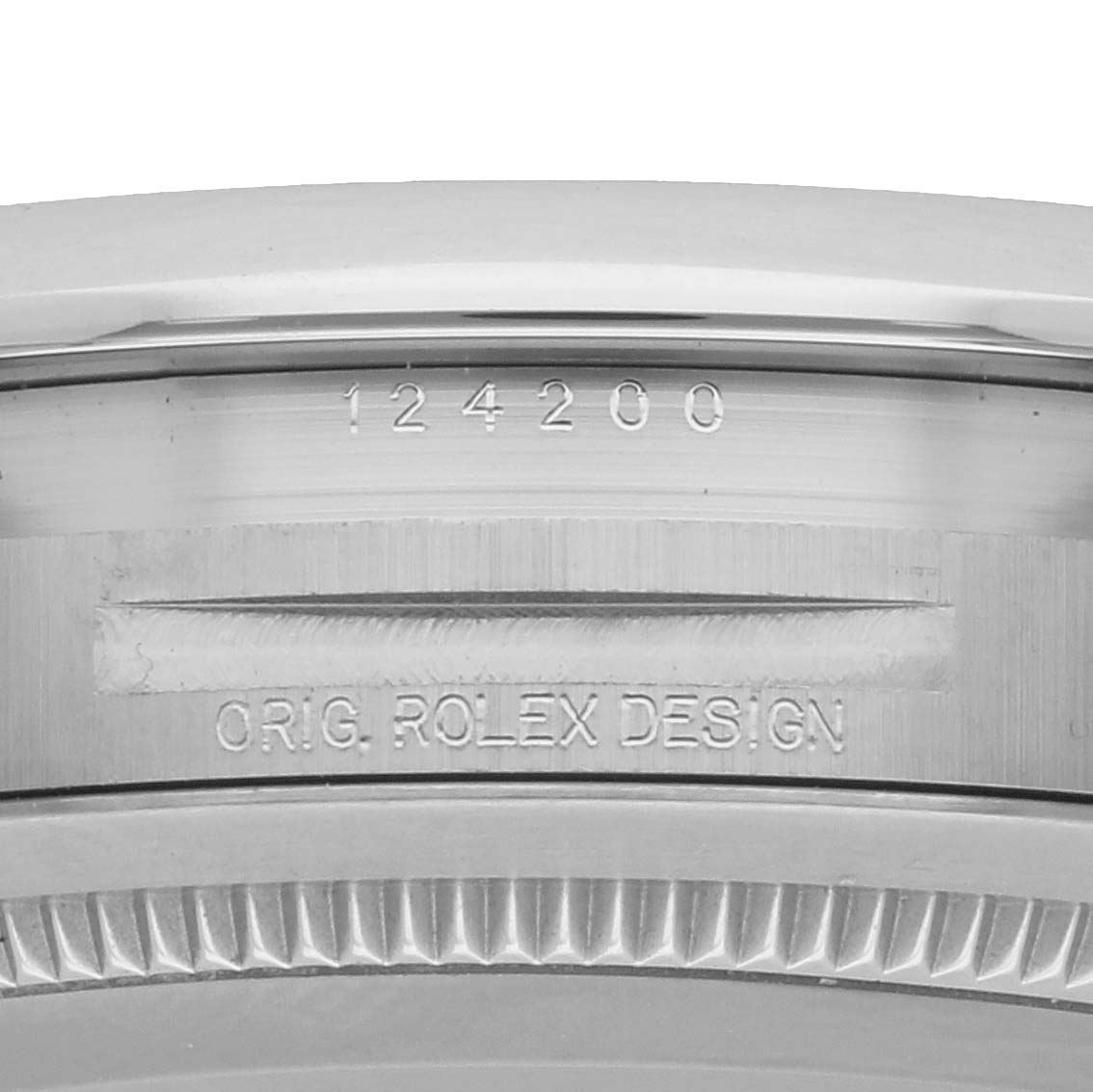 The image shows a close-up of the case side of a Rolex Oyster Perpetual 124200 Men
s Stainless Steel Green Dial, highlighting the model number and "ORIG. ROLEX DESIGN" engraving.