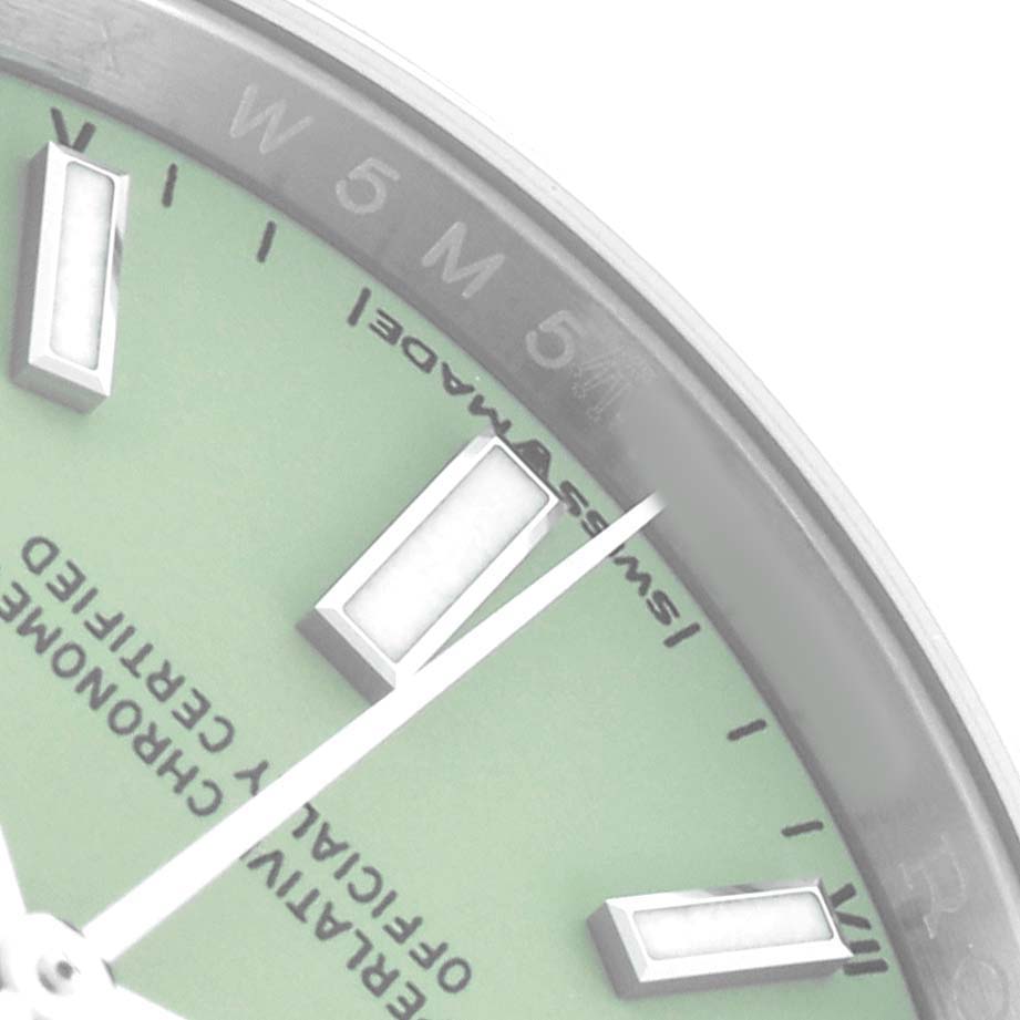 The image shows a close-up of the Rolex Oyster Perpetual 124200 Men
s Stainless Steel Green Dial watch, focusing on its dial, markers, and part of the bezel.