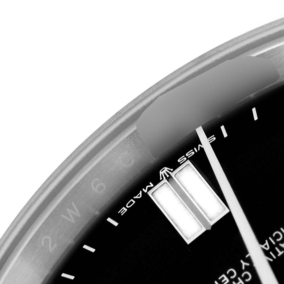 This close-up angle of the Rolex Oyster Perpetual 124300 Men
s Stainless Steel Black Dial 124300 Men
s Stainless Steel Black Dial watch shows a portion of the dial, including the Swiss Made mark and luminous hour markers.