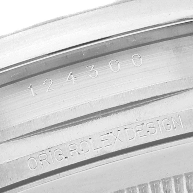 This image shows a close-up of the engraved model number and "Orig. Rolex Design" on the case of a Rolex Oyster Perpetual 124300 Men
s Stainless Steel Black Dial 124300 Men
s Stainless Steel Black Dial watch.