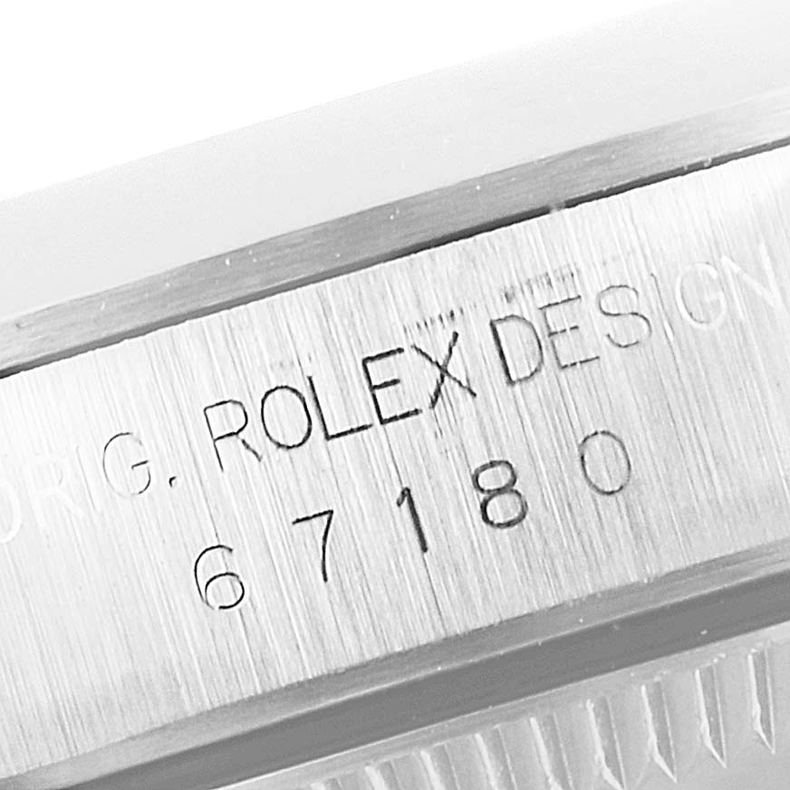This image shows the side view of the bezel with engraved serial number and "Rolex Design" on a Rolex Oyster Perpetual 67180 Women's Stainless Steel Silver Dial 67180 Women's Stainless Steel Silver Dial watch.
