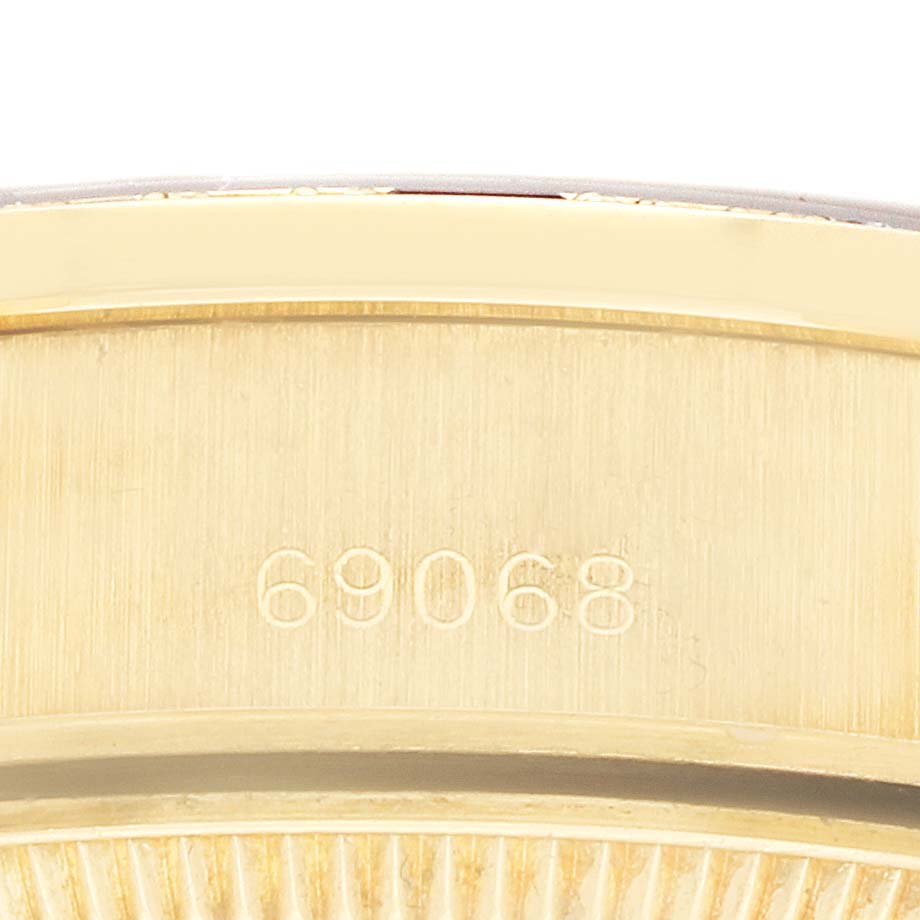 The image shows a close-up of the serial number engraving on the case of a Rolex President 69068 Women
s Yellow Gold Champagne Dial model watch.