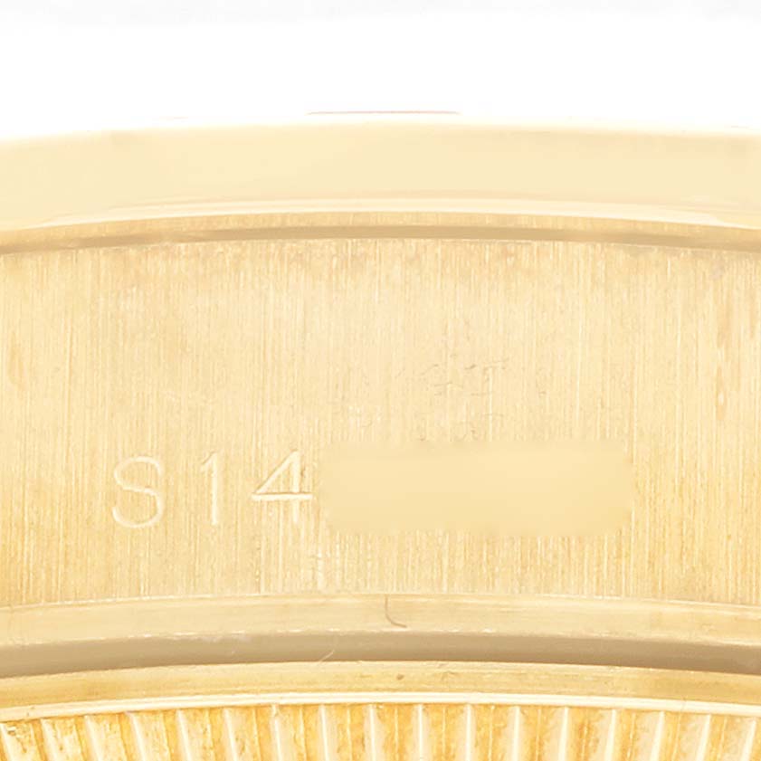 The image shows the side of a Rolex President 69068 Women
s Yellow Gold Champagne Dial model watch, focusing on the engraved model or serial numbers.