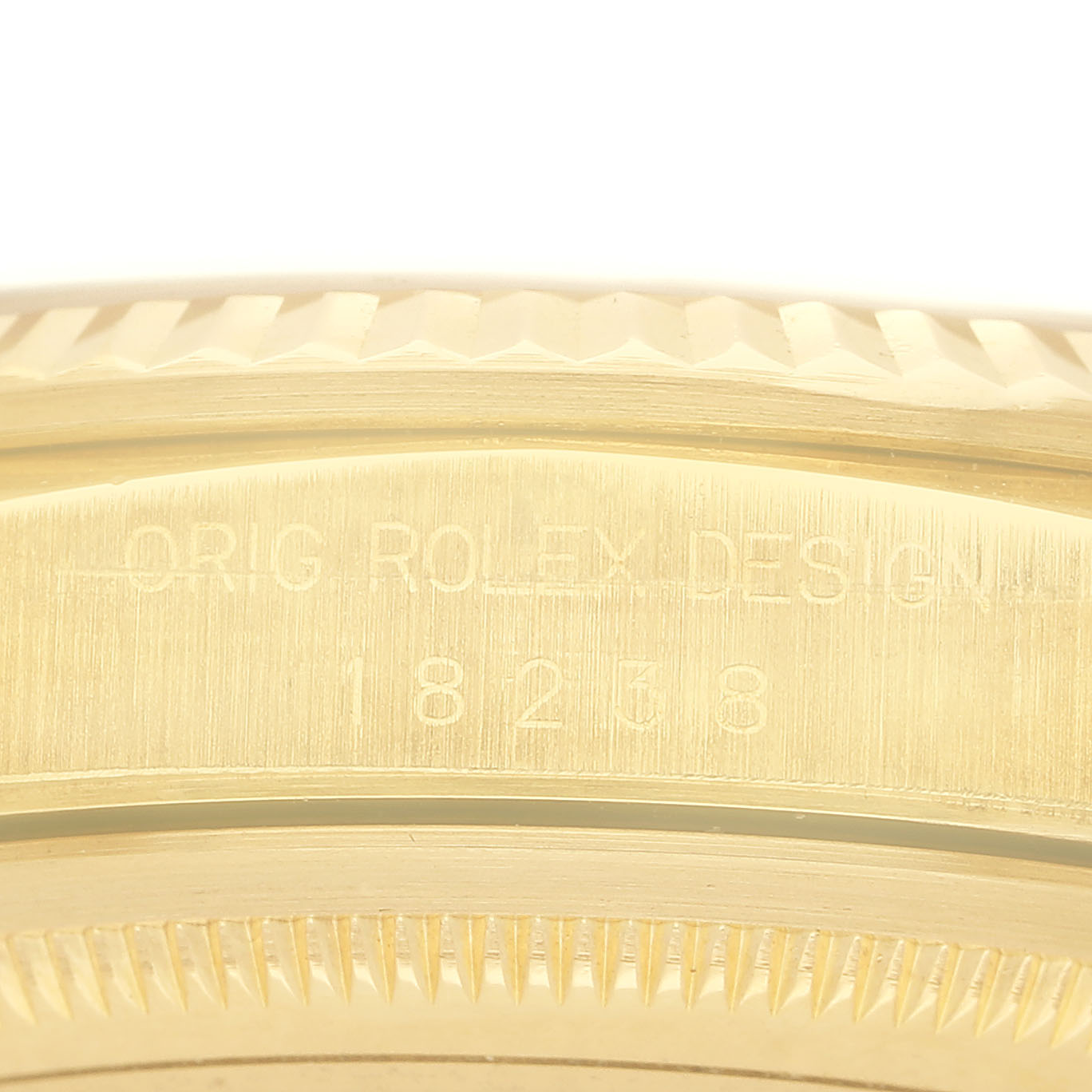 The image shows a close-up of the engraved side of the Rolex President 18238 Men's Yellow Gold Champagne Dial model with visible fluted bezel details.