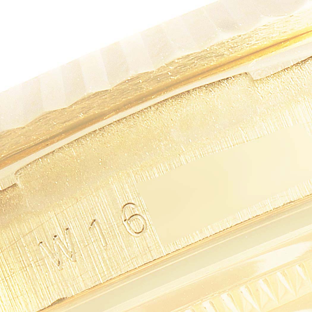 This close-up image features part of the fluted bezel and the case side of a Rolex President 18238 Men's Yellow Gold Champagne Dial 18238 Men's Yellow Gold Champagne Dial model watch.