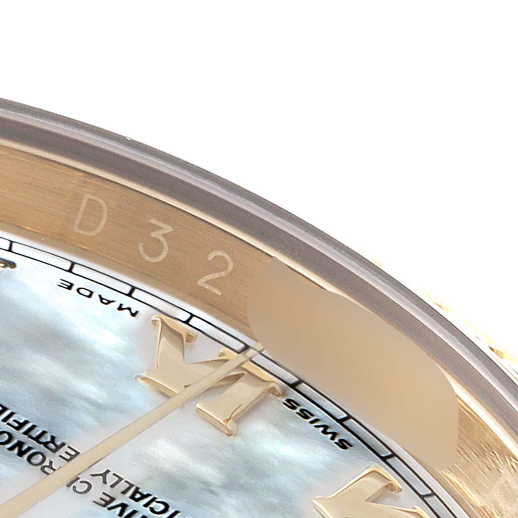 This close-up image of the Rolex Datejust 116188 Men's Yellow Gold Mother of Pearl Dial 116188 Men's Yellow Gold Mother of Pearl Dial watch shows the dial, part of the Roman numeral marker, and the rehaut engraving.