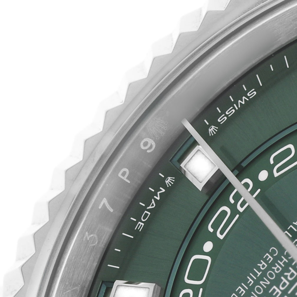 The image shows a close-up of the dial and fluted bezel of the Rolex Sky-Dweller 336934 Men's Stainless Steel Green Dial watch, highlighting the hour markers and part of the hands.