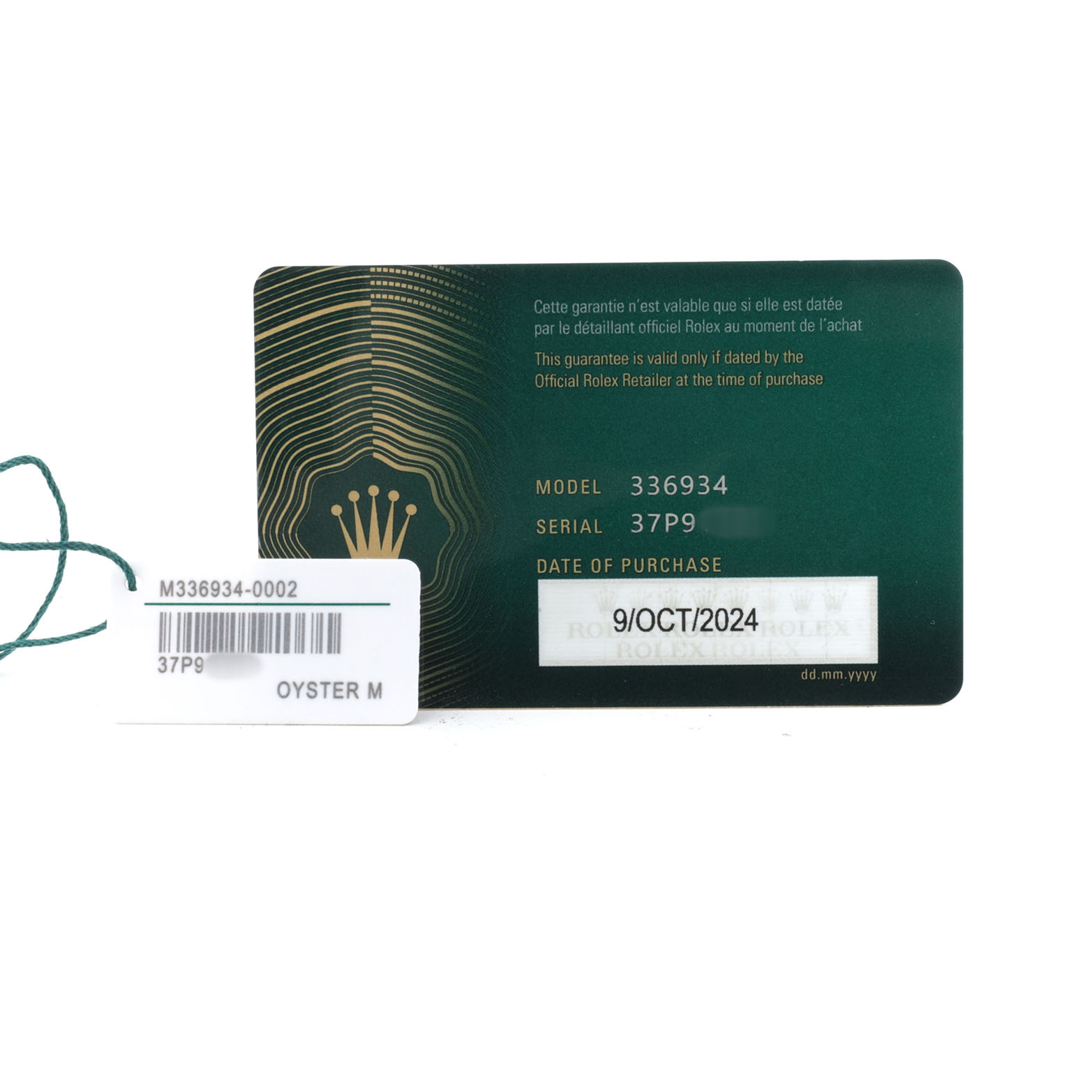The image shows a warranty card and a tag for the Rolex Sky-Dweller 336934 Men's Stainless Steel Green Dial model, displaying model and serial numbers.