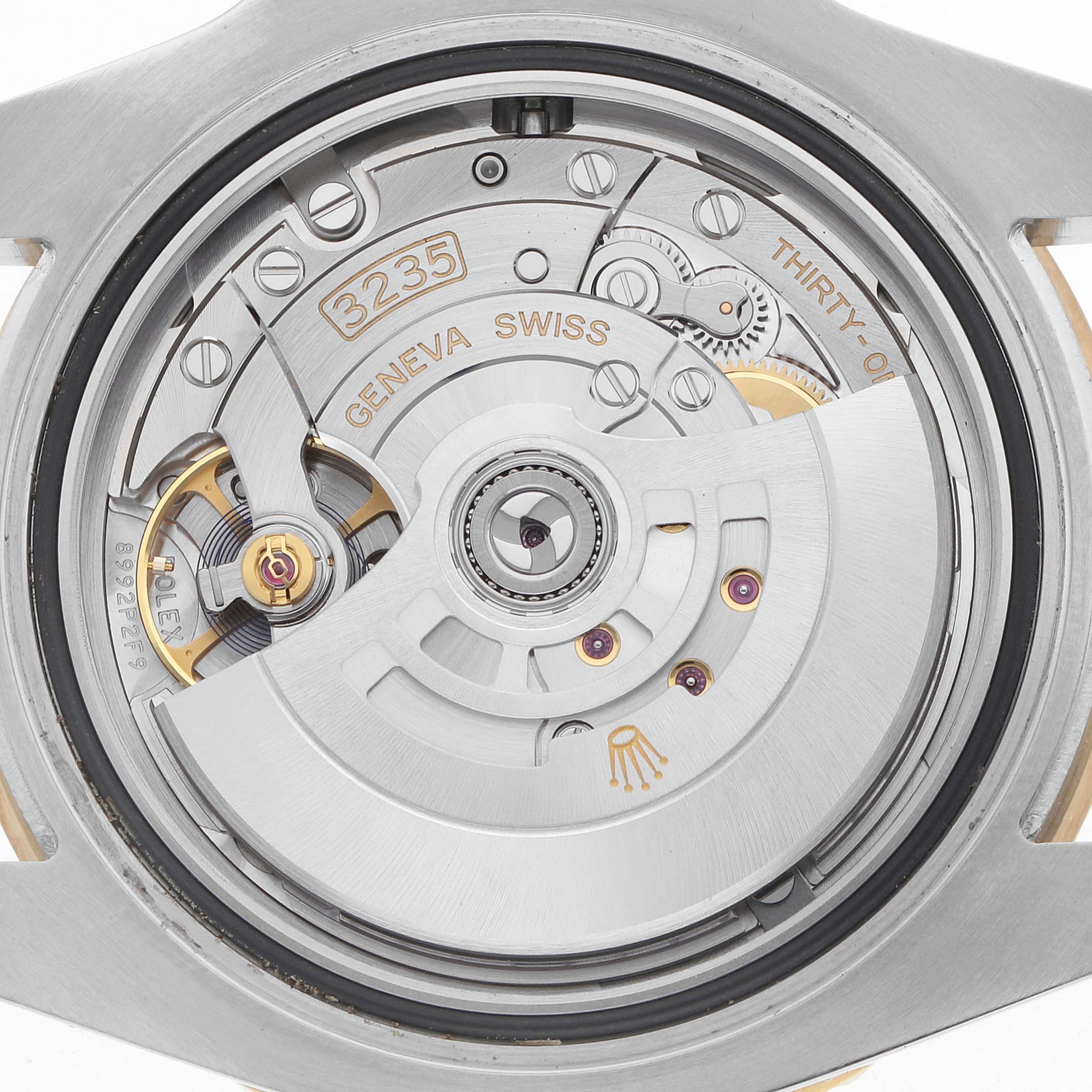 The image shows the movement of a Rolex Submariner 126613 Men's Steel and Gold (two tone) Black Dial, highlighting the rotor, balance wheel, and engraved details.