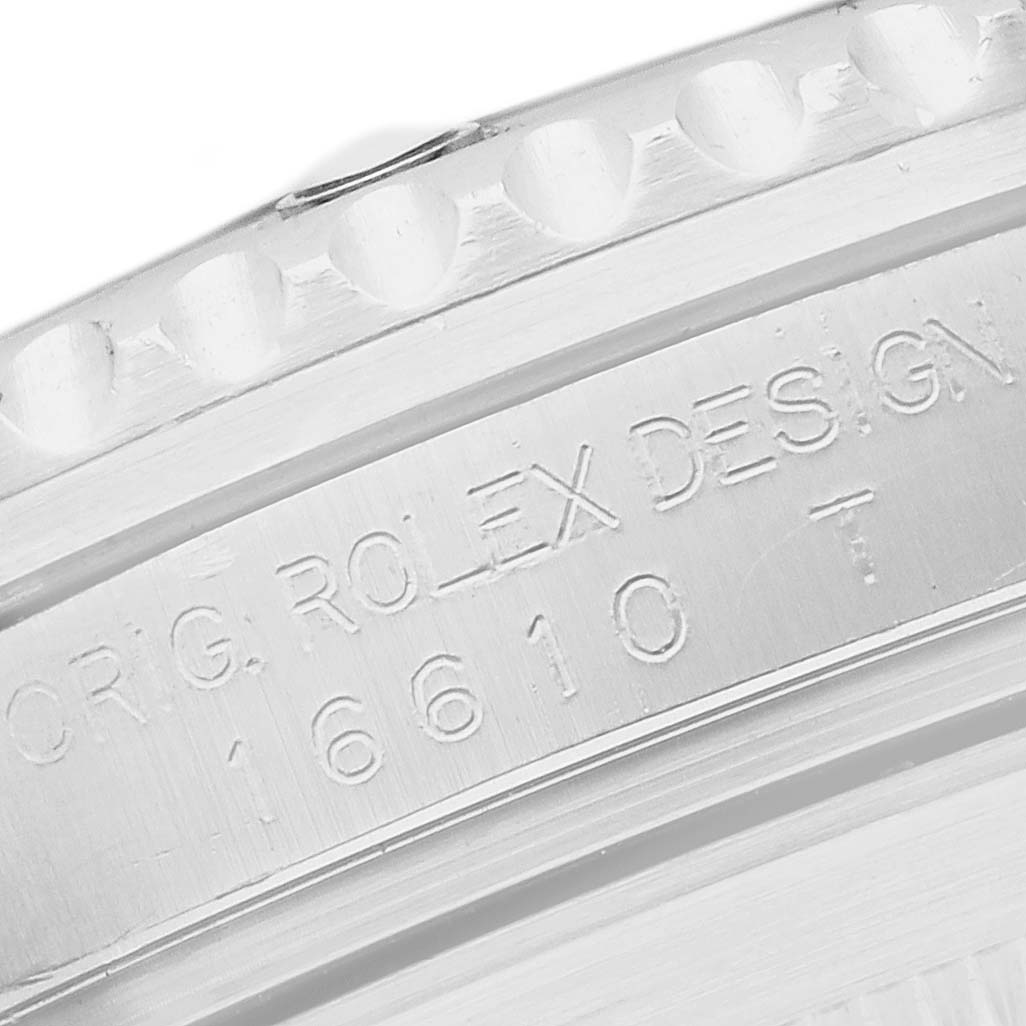 The image shows a close-up of the engraved bezel and case side of the Rolex Submariner 16610 Men
s Stainless Steel Black Dial model.