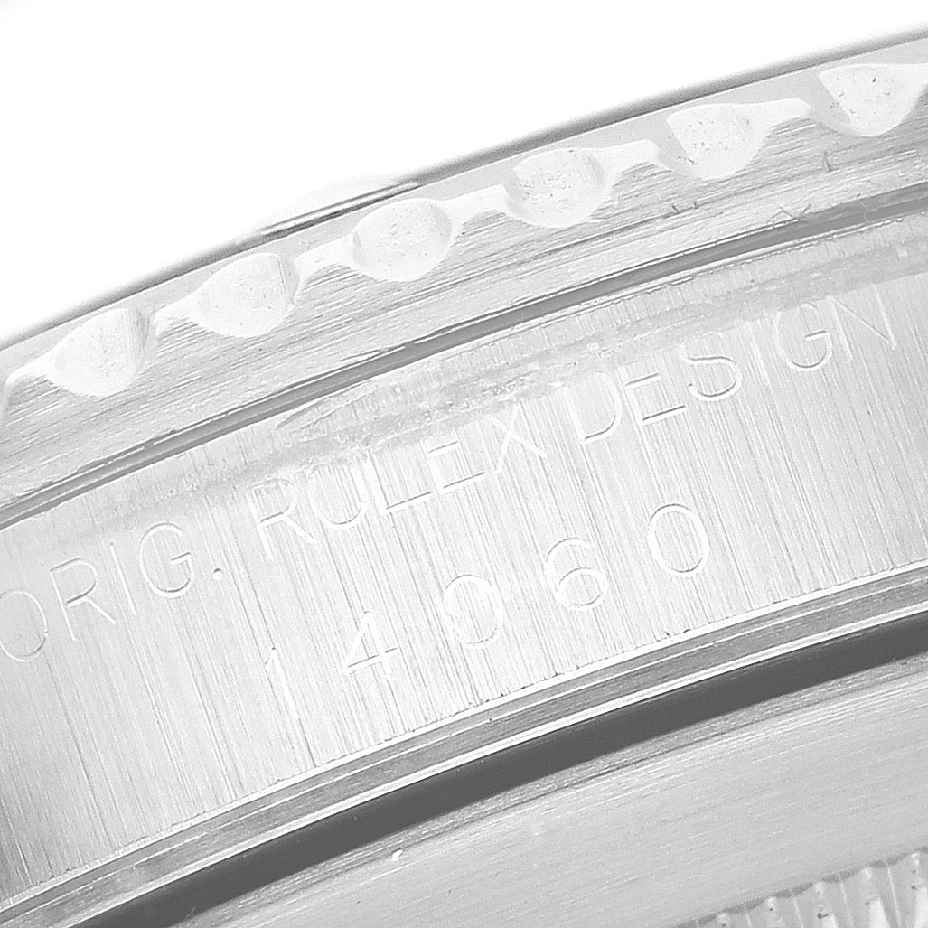The image shows a close-up view of the Rolex Submariner 14060 Men's Stainless Steel Black Dial's engraved case with reference numbers and part of the bezel edge.