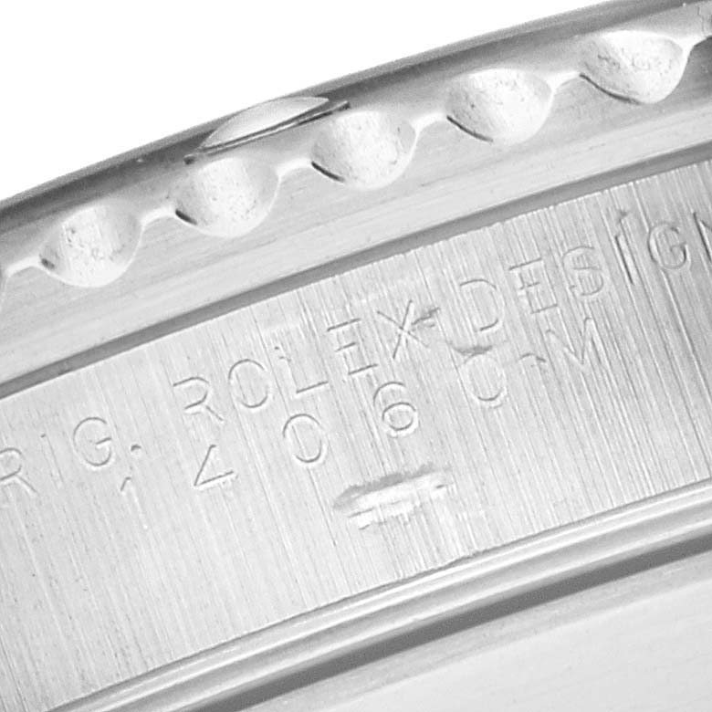 The image shows a close-up of the edge and engravings on the bezel of a Rolex Submariner 14060 Men
s Stainless Steel Black Dial 14060 Men
s Stainless Steel Black Dial watch.