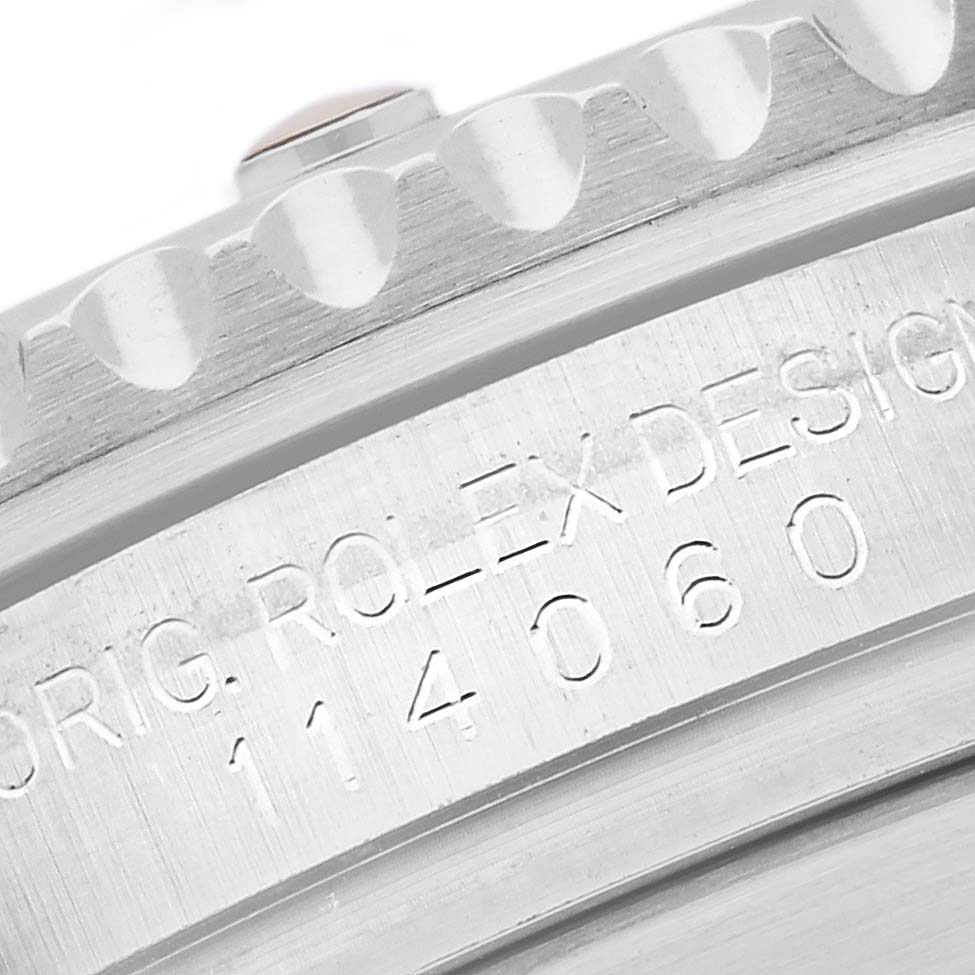 The image shows a close-up of the bezel and engraved serial number of a Rolex Submariner 114060LN Men
s Stainless Steel Black Dial 114060LN Men
s Stainless Steel Black Dial watch.