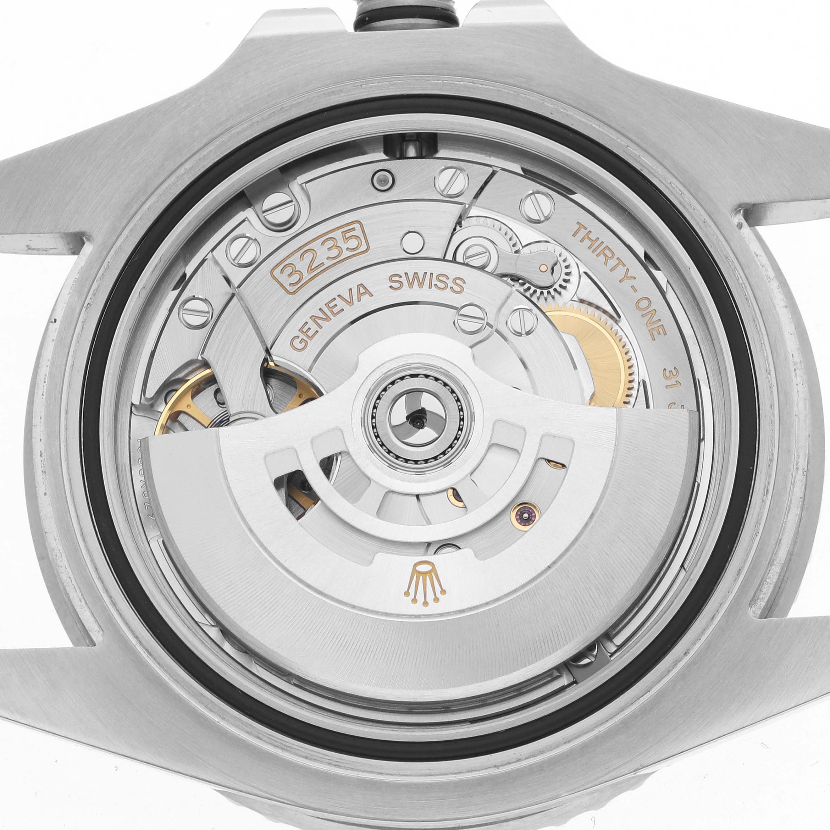 The image shows a close-up view of the Rolex Submariner 126610 Men
s Stainless Steel Black Dial
s movement, specifically the automatic rotor and internal components.