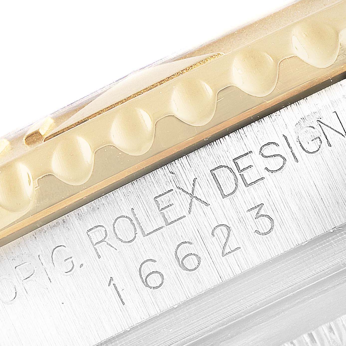 The image shows a close-up view of the case side and bezel serration of the Rolex Yacht-Master 16623 Men's Steel and Gold (two tone) White Dial 16623 Men's Steel and Gold (two tone) White Dial, with the model number 16623 engraved.