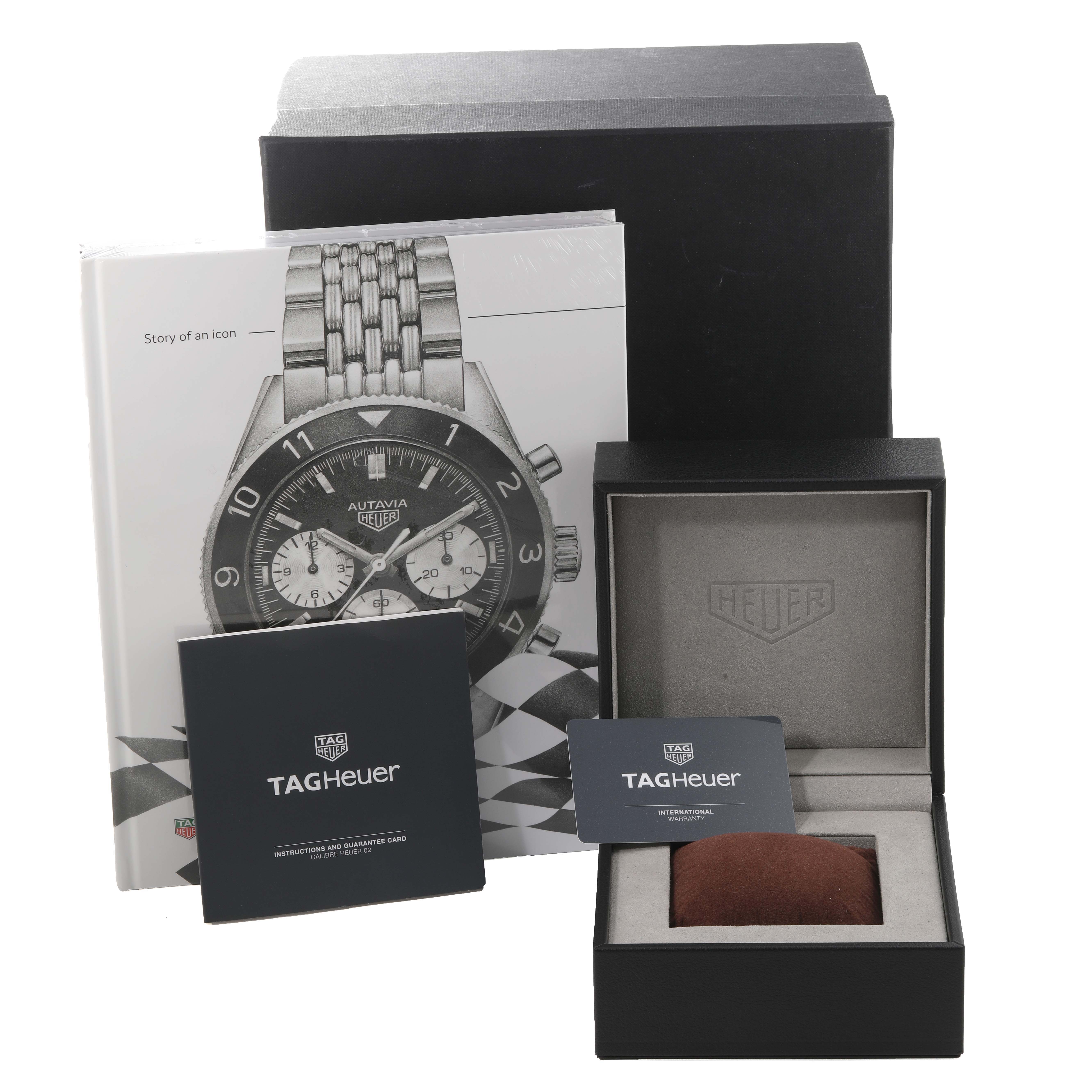 The image shows the packaging, book, warranty card, and presentation box for the Tag Heuer Limited Edition Autavia model.