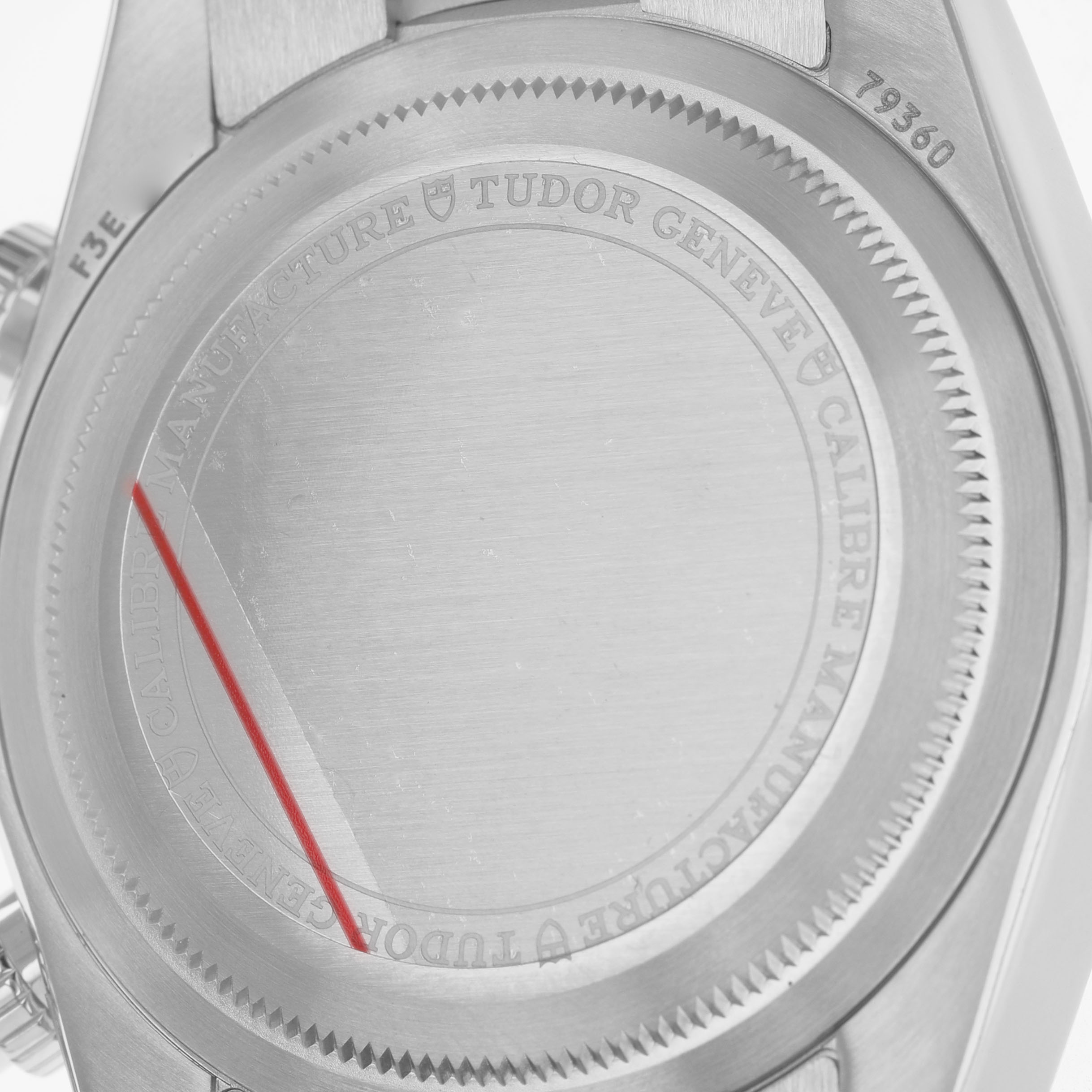 The image shows the back case of the Tudor Heritage Black Bay 79360 Men's Stainless Steel Silver Dial watch, highlighting the engravings and serial number.