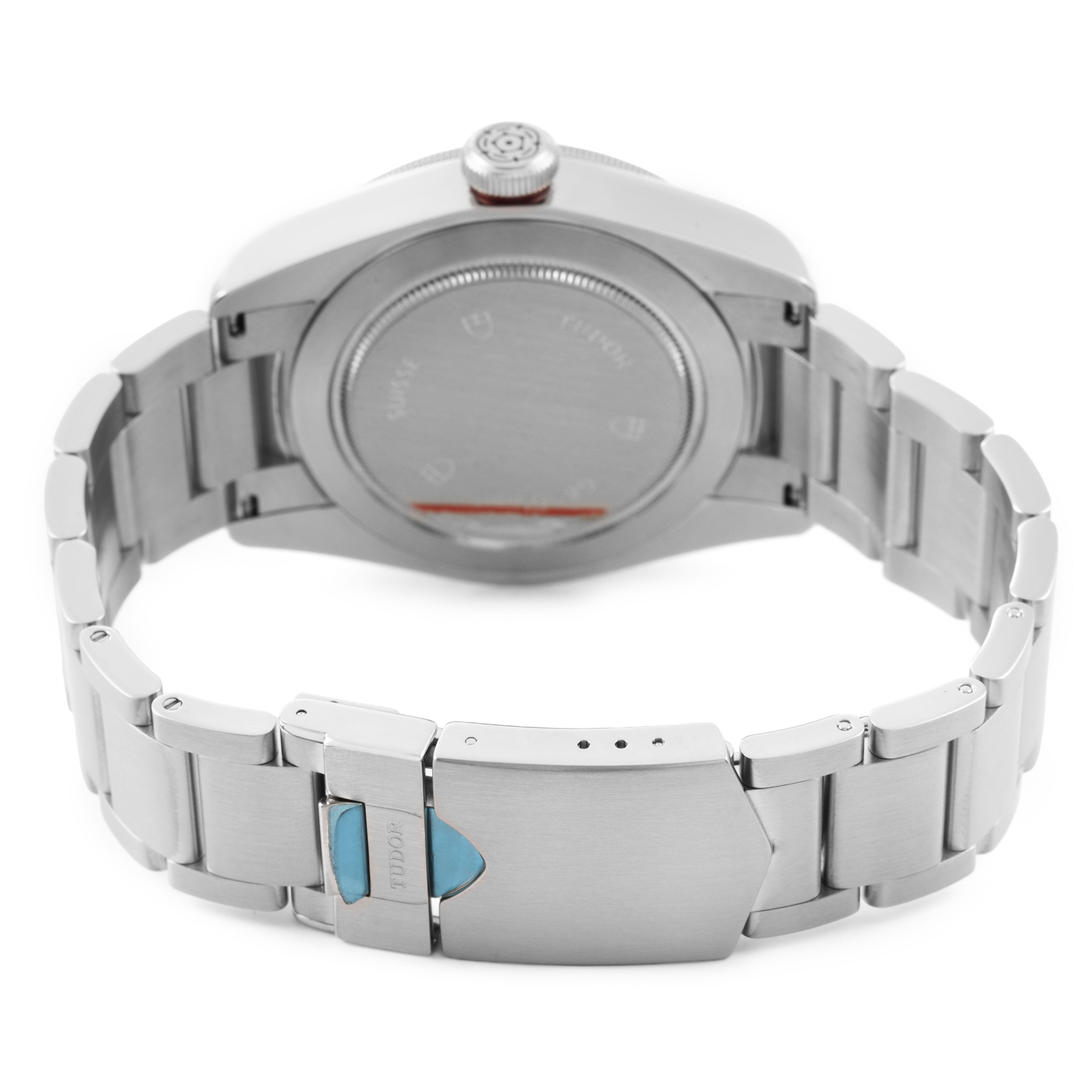 The image shows the back view of a Tudor Heritage Black Bay 79220R Men's Stainless Steel Black Dial watch, highlighting the bracelet and clasp.