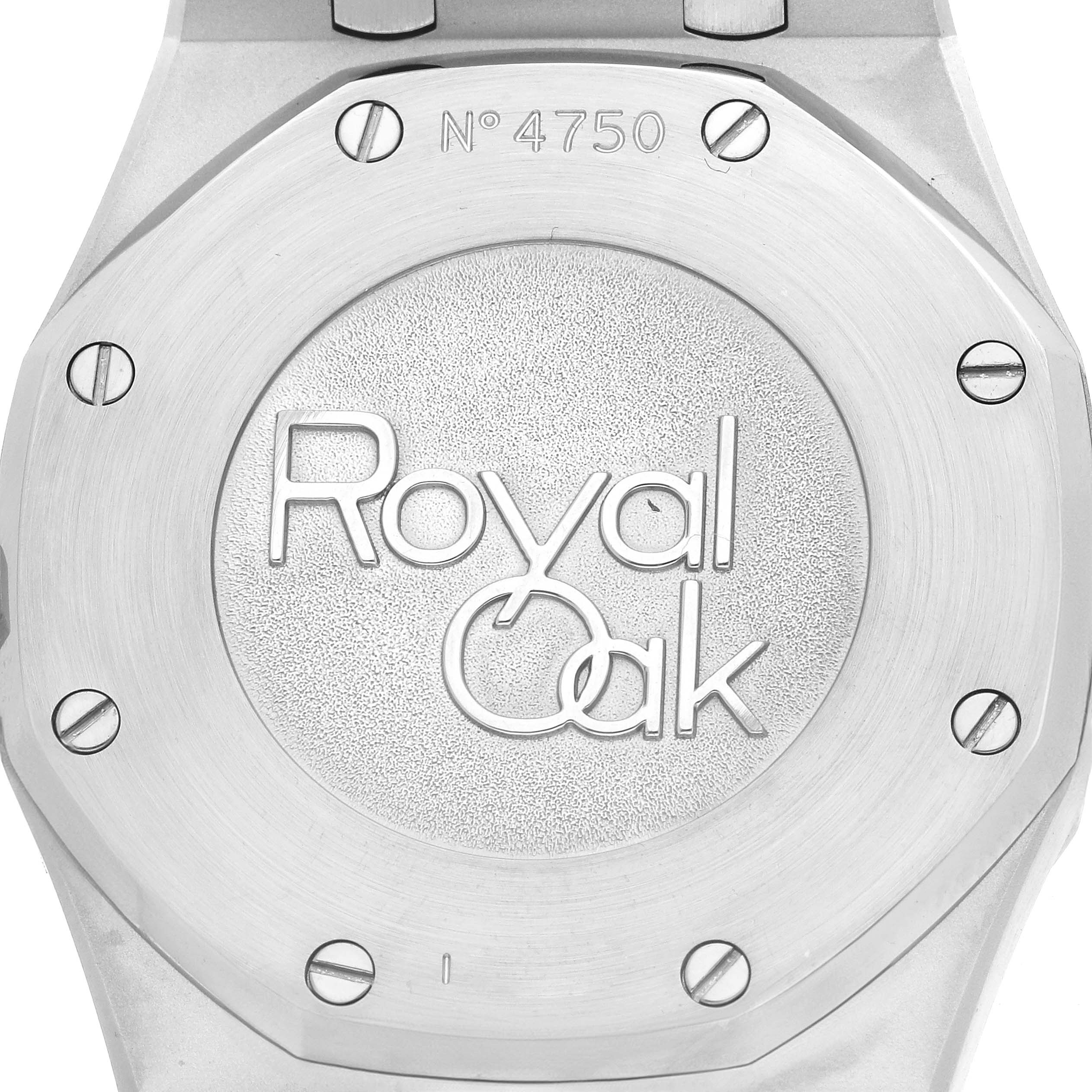 The image shows the back case of an Audemars Piguet Royal Oak 26120ST Men
s Stainless Steel Silver Dial watch with its screws and the model name engraved.