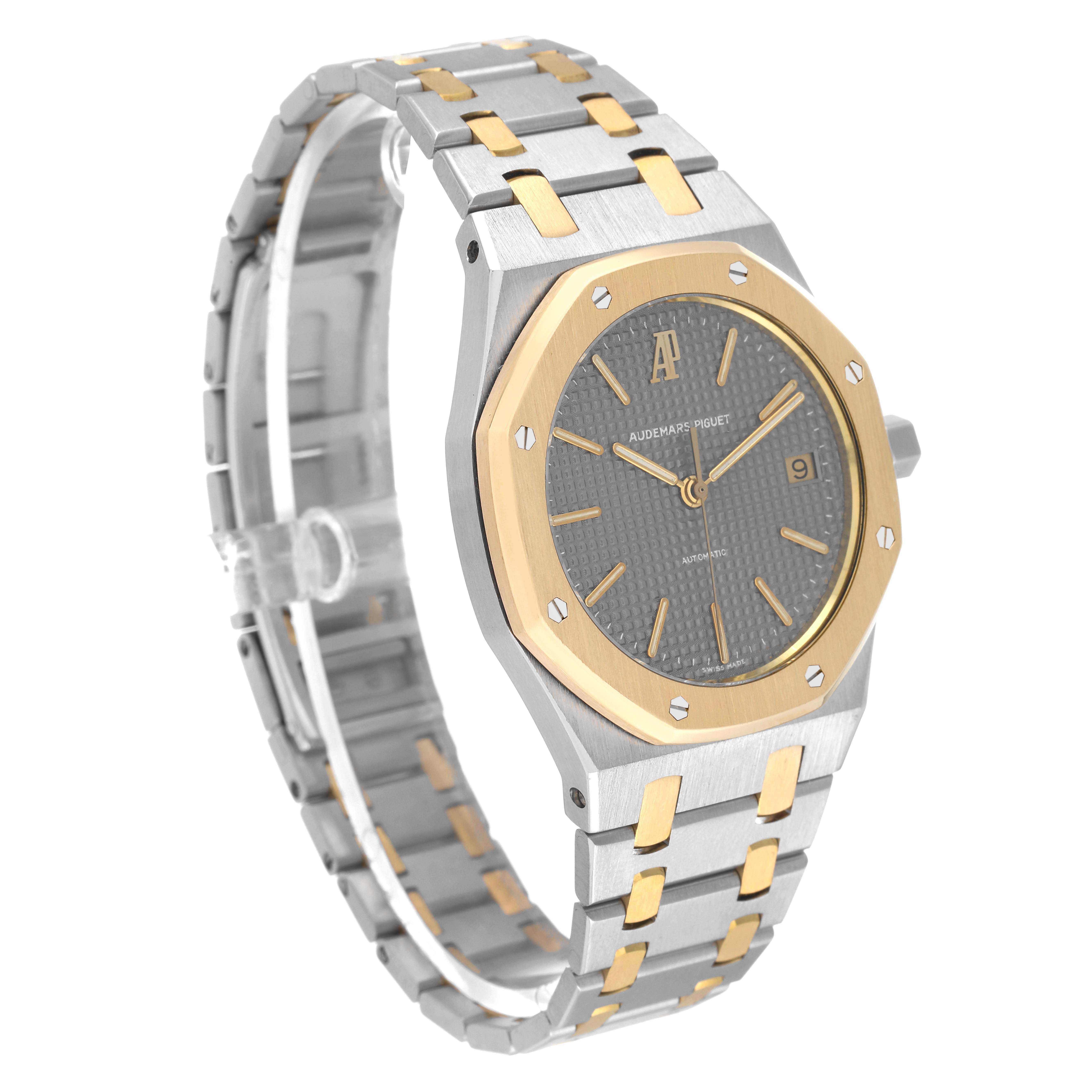 The Audemars Piguet Royal Oak 14790SA.OO.0789SA.01 Men
s Steel and Gold (two tone) Grey Dial 14790SA.OO.0789SA.01 Men
s Steel and Gold (two tone) Grey Dial watch is shown at a slight angle, highlighting the face, bezel, and bracelet.