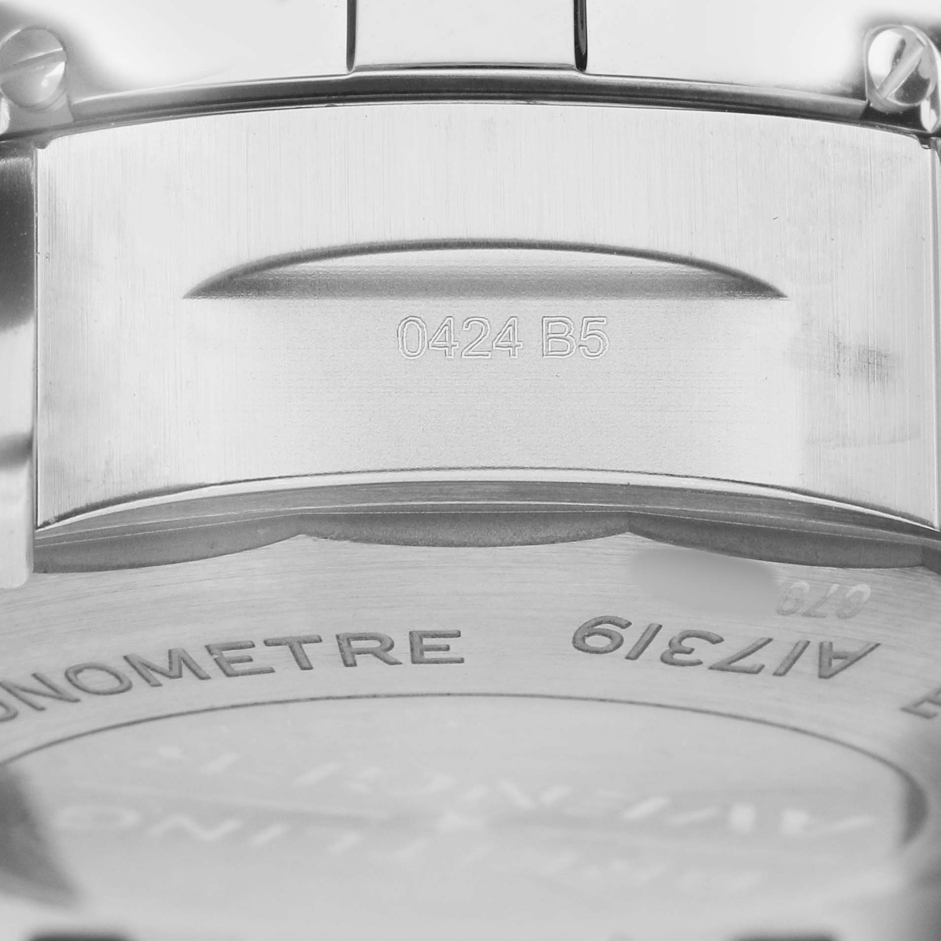 The image shows the back casing and clasp of a Breitling Avenger A17319 Men
s Stainless Steel Yellow Dial watch, highlighting engravings and text.