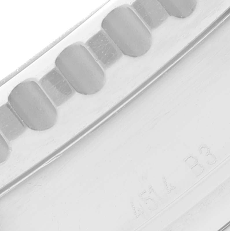 This is a close-up of the bezel of the Breitling Navitimer A23322 Men's Stainless Steel Black Dial A23322 Men's Stainless Steel Black Dial watch model, showing part of the notched edge and engraved markings.