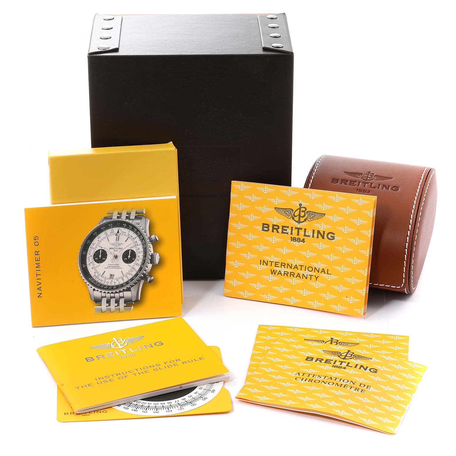 The image shows Breitling Navitimer A23330 Men
s Stainless Steel Silver Dial A23330 Men
s Stainless Steel Silver Dial watch accessories including manuals, warranty cards, a leather case, and a presentation box.