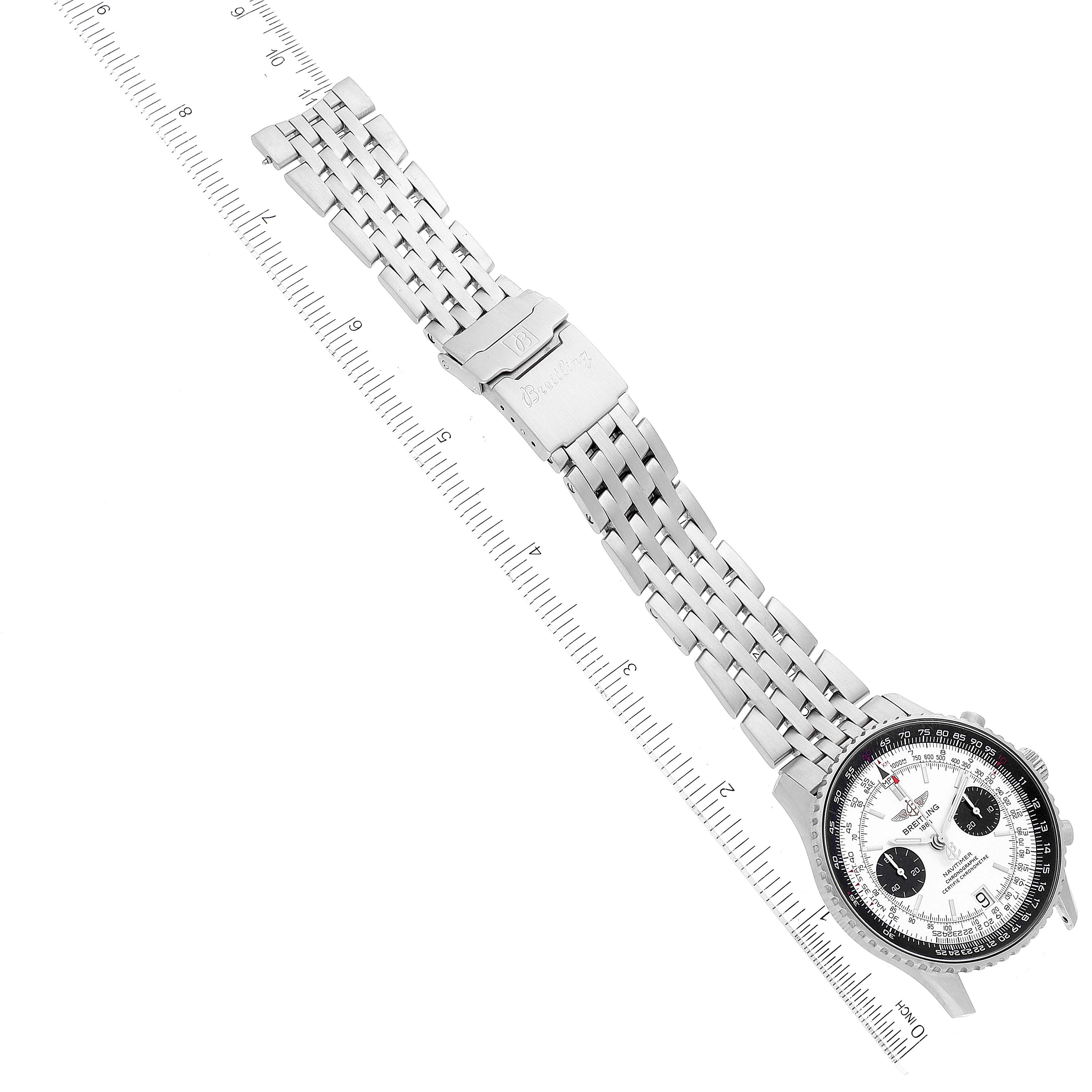 The image shows a top-down view of a Breitling Navitimer A23330 Men
s Stainless Steel Silver Dial A23330 Men
s Stainless Steel Silver Dial watch with its entire metal bracelet extended alongside a ruler.