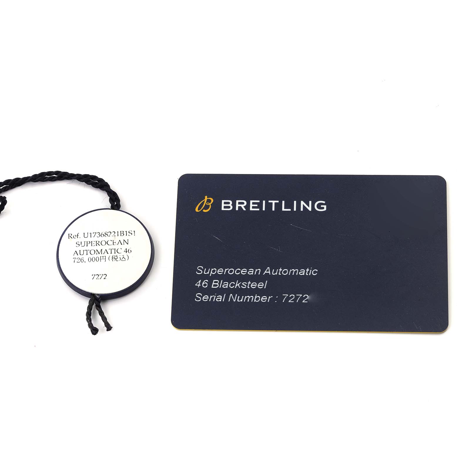 The image shows the Breitling Superocean U17368 Men's Steel and Gold (two tone) Black Dial U17368 Men's Steel and Gold (two tone) Black Dial Automatic 46 Blacksteel tag and authenticity card from a top view.