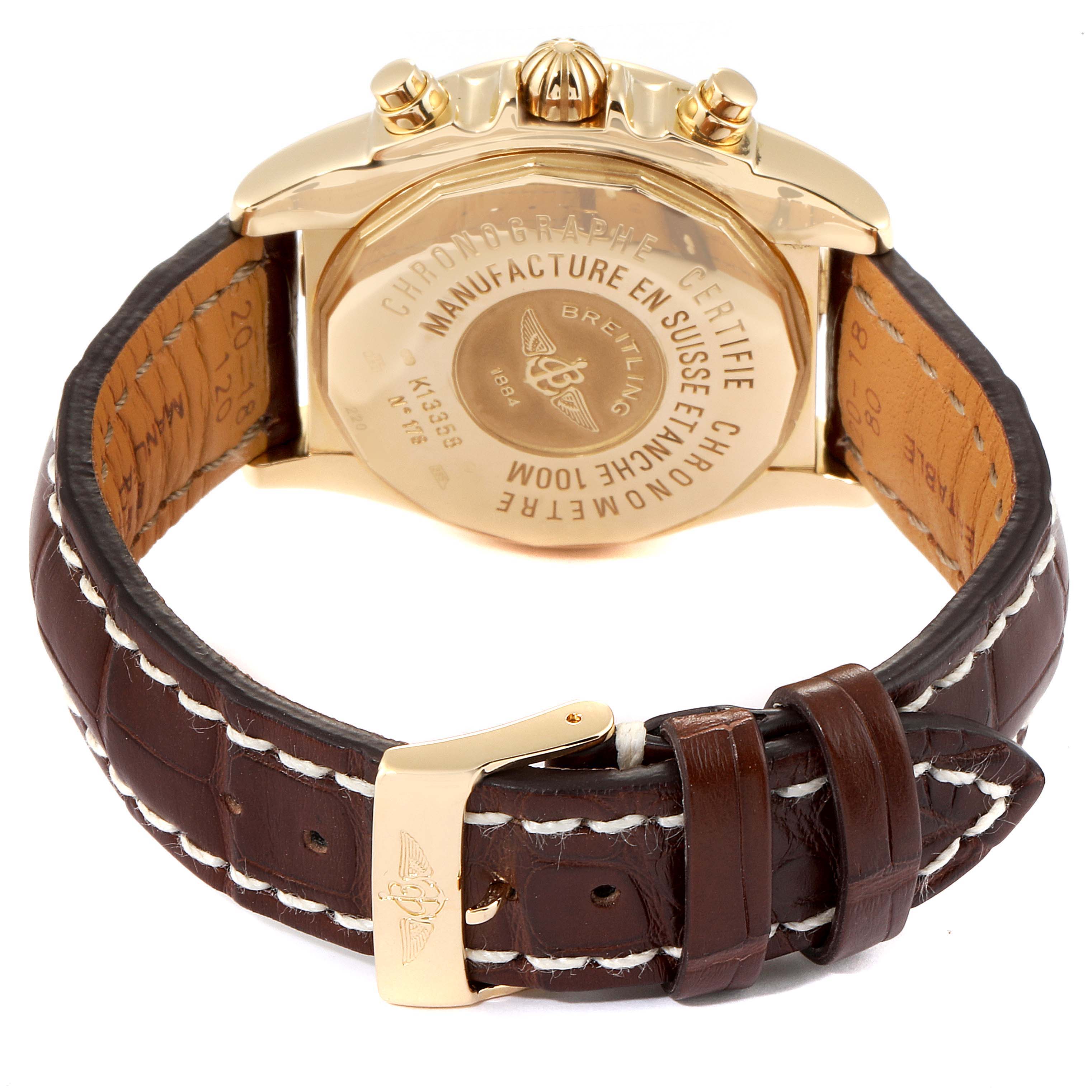 The image shows the back view of a Breitling Windrider K13358 Men's Yellow Gold Mother of Pearl Dial K13358 Men's Yellow Gold Mother of Pearl Dial watch, highlighting the case back and leather strap with stitching.