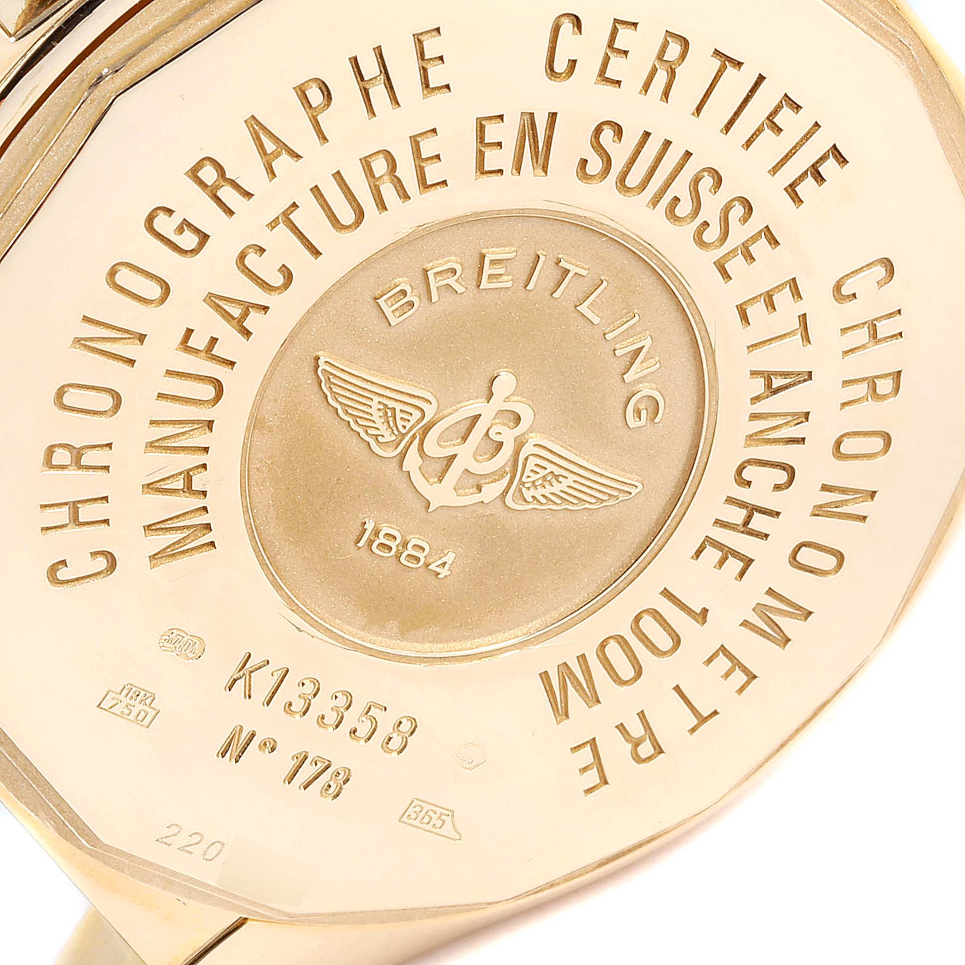 The image shows the backside of a Breitling Windrider K13358 Men's Yellow Gold Mother of Pearl Dial K13358 Men's Yellow Gold Mother of Pearl Dial watch, highlighting its engraved details and model number.