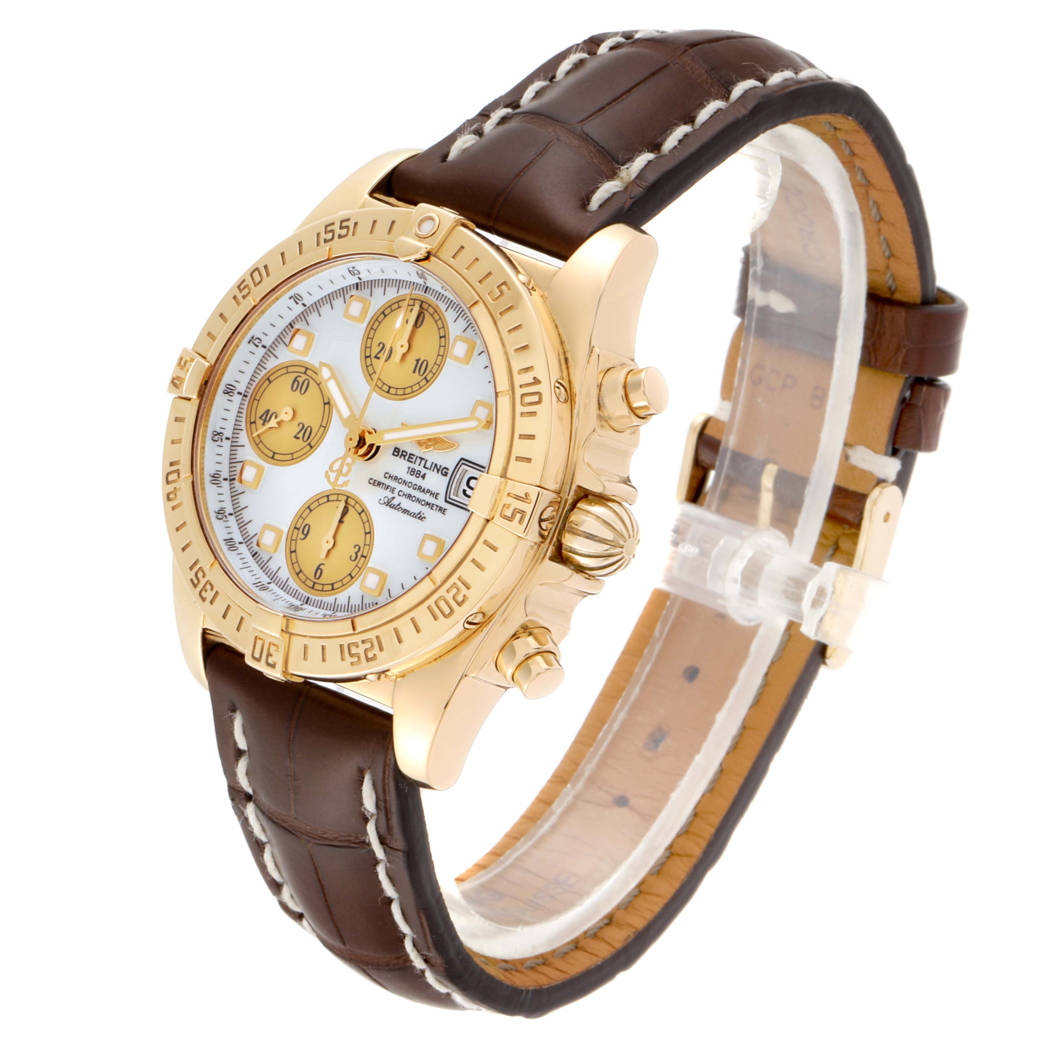 The image shows a Breitling Windrider K13358 Men's Yellow Gold Mother of Pearl Dial K13358 Men's Yellow Gold Mother of Pearl Dial watch at a three-quarter angle, highlighting its gold case, chronograph dials, and brown leather strap.