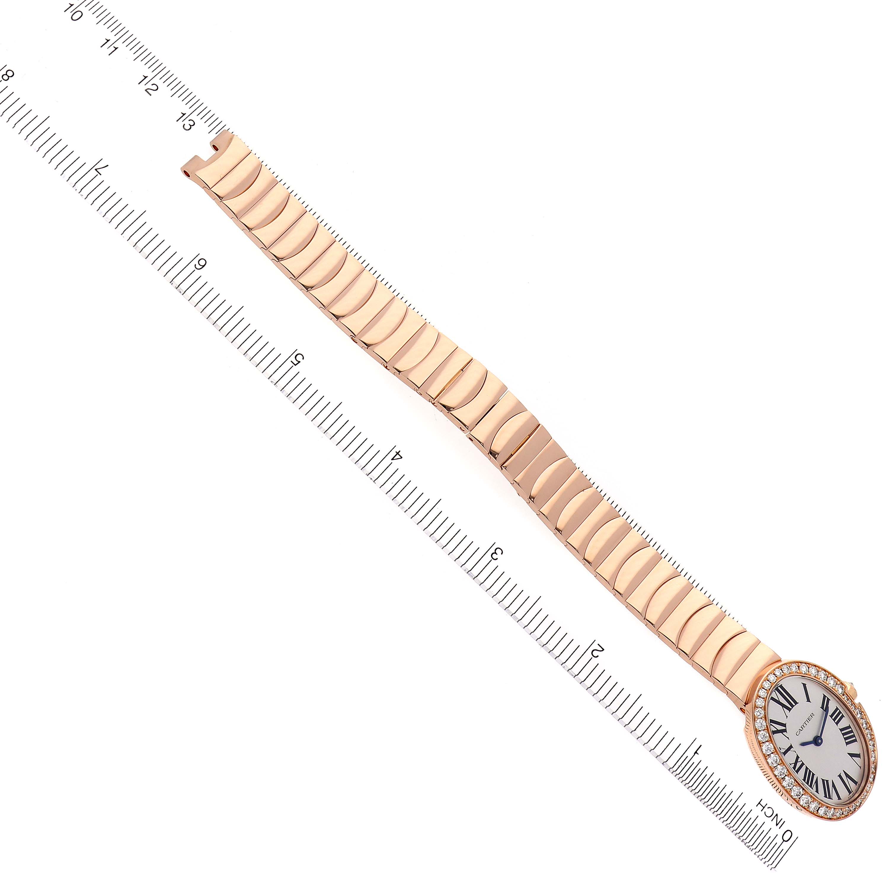 The Cartier Baignoire WB520002 Women
s Rose Gold Silver Dial WB520002 Women
s Rose Gold Silver Dial watch is shown from an overhead angle, displaying the entire bracelet and face with a ruler for scale.