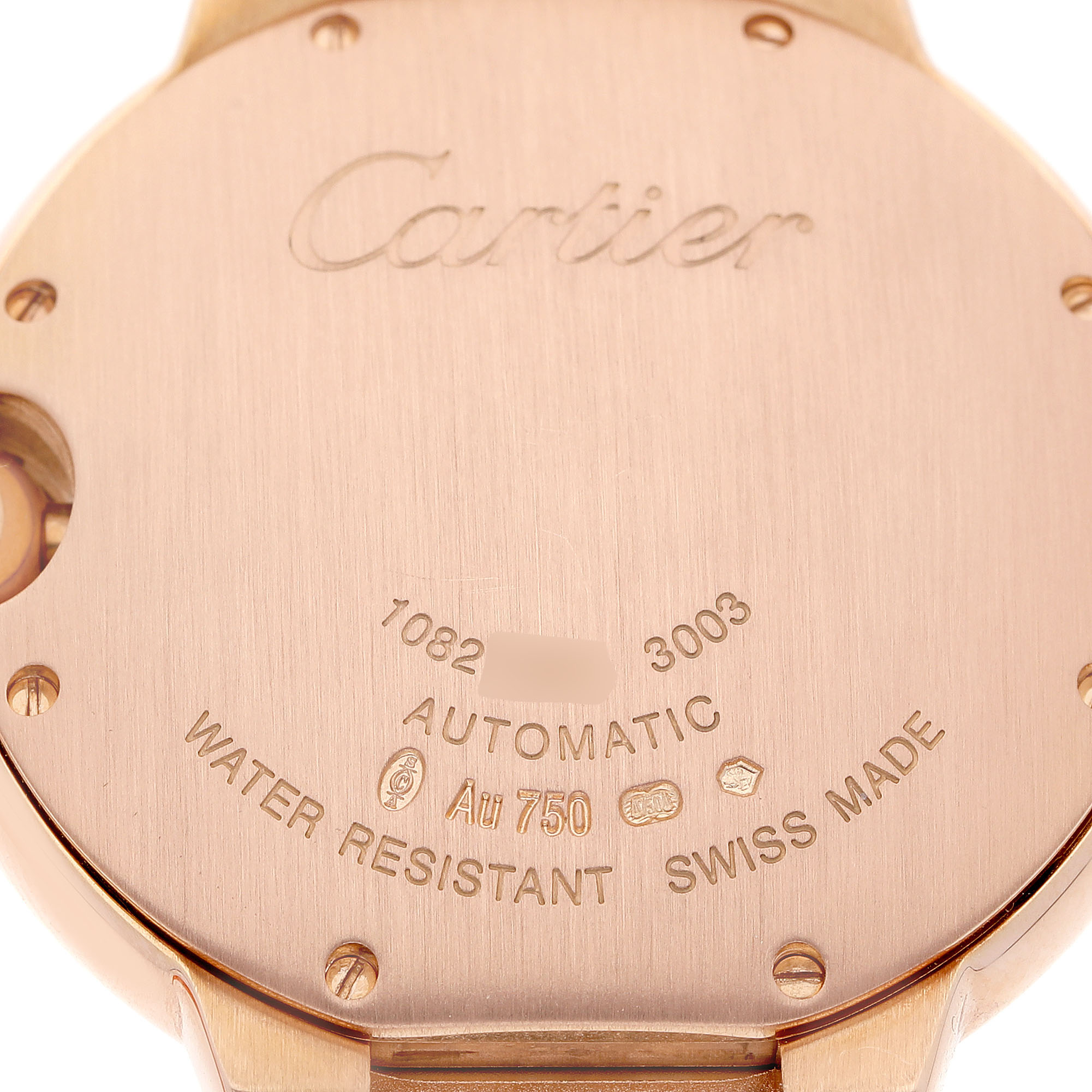 The image shows the back of a Cartier Ballon Bleu WE9005Z3 Women's Rose Gold Silver Dial watch, highlighting engravings and the case material.