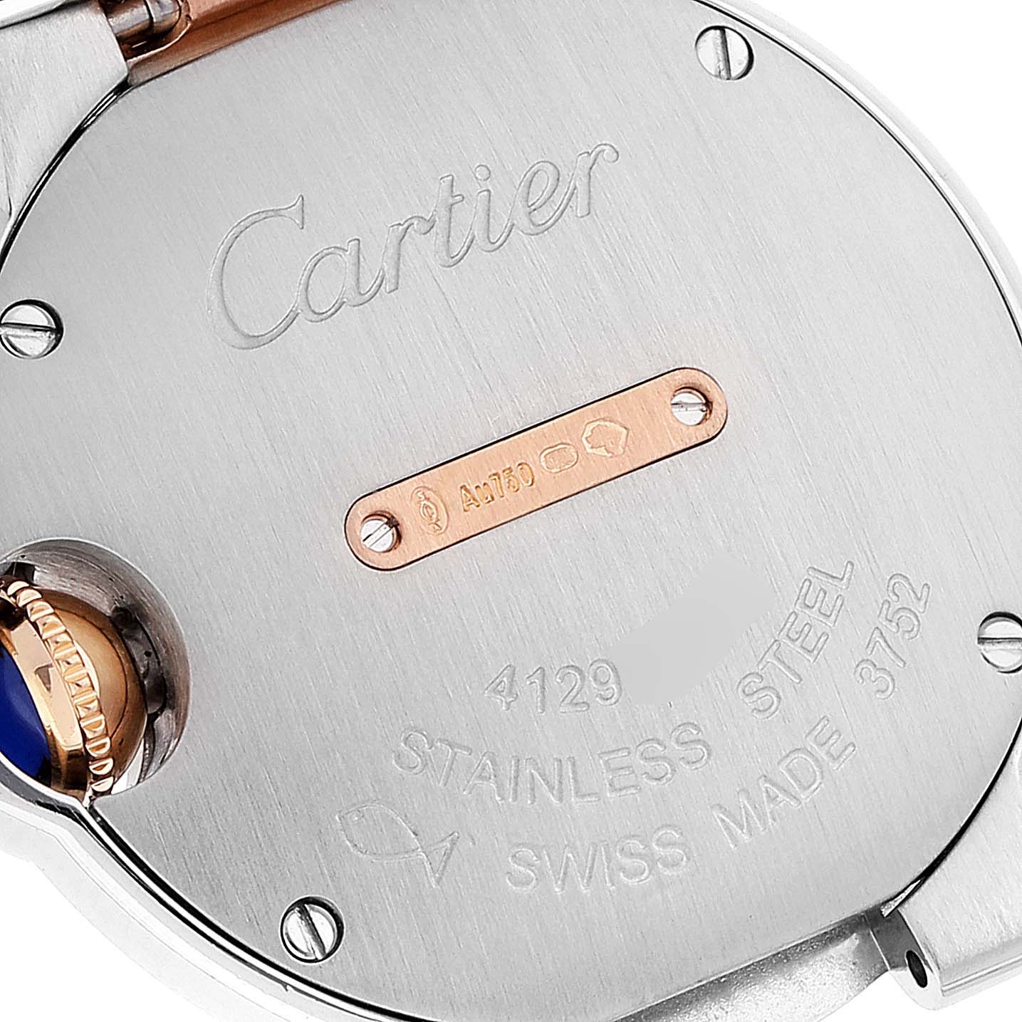 The image shows the back case of a Cartier Ballon Bleu W3BB0009 Women's Steel and Gold (two tone) Silver Dial W3BB0009 Women's Steel and Gold (two tone) Silver Dial watch, featuring engravings and the crown with a blue accent.