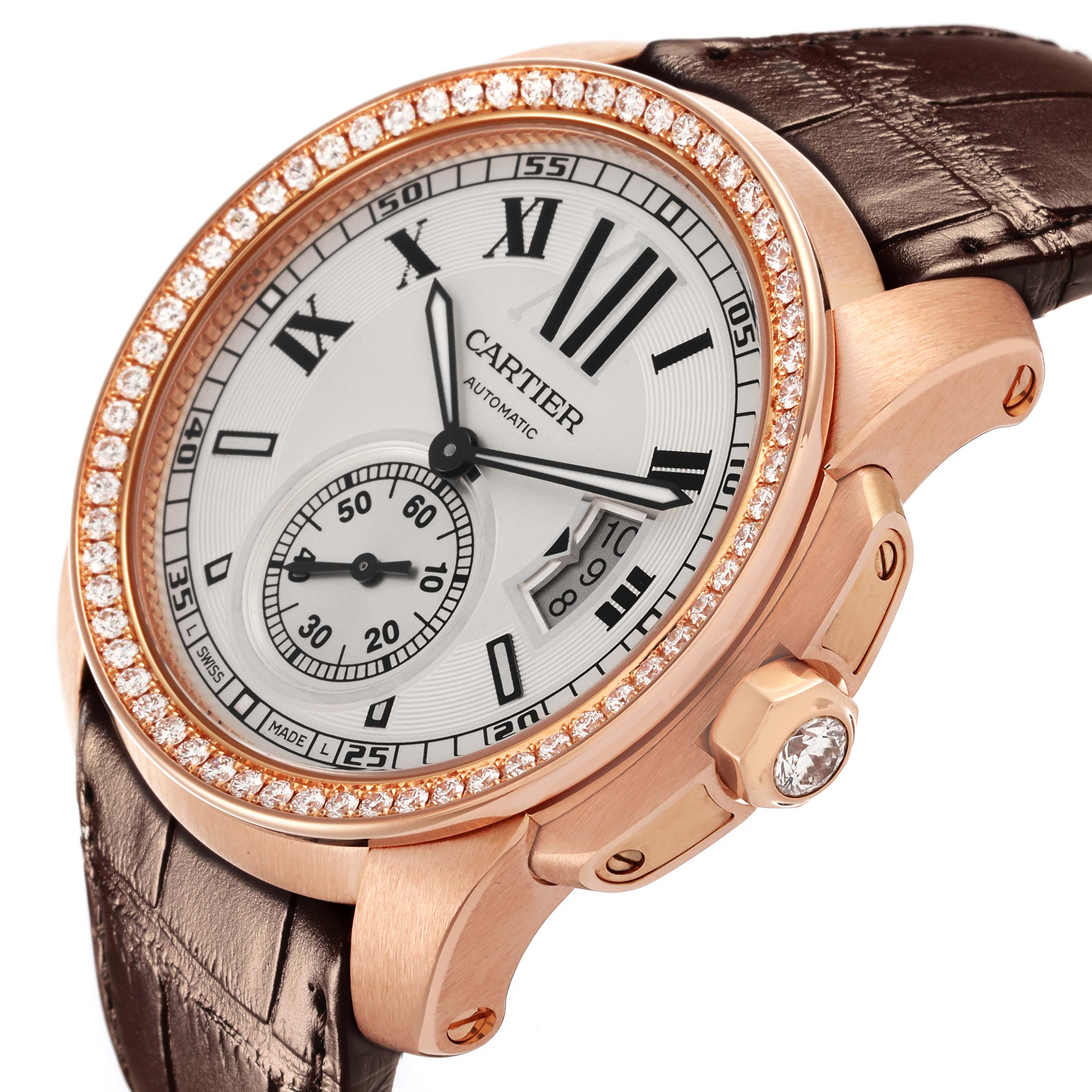 The Calibre de Cartier watch is shown at a three-quarter angle, highlighting the dial, bezel, crown, and leather strap.