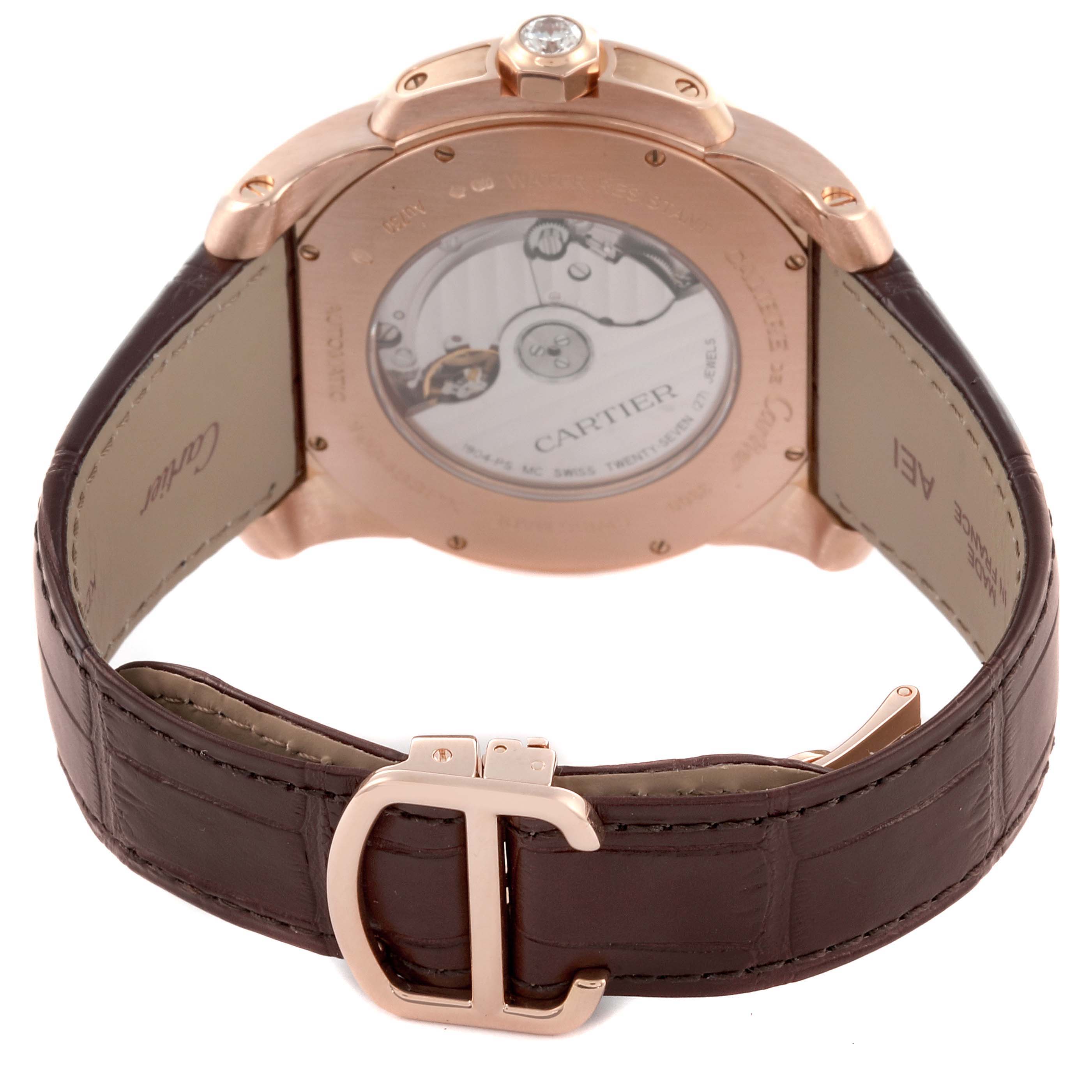 The image shows the back view of a Calibre de Cartier watch, including the case back and clasp.