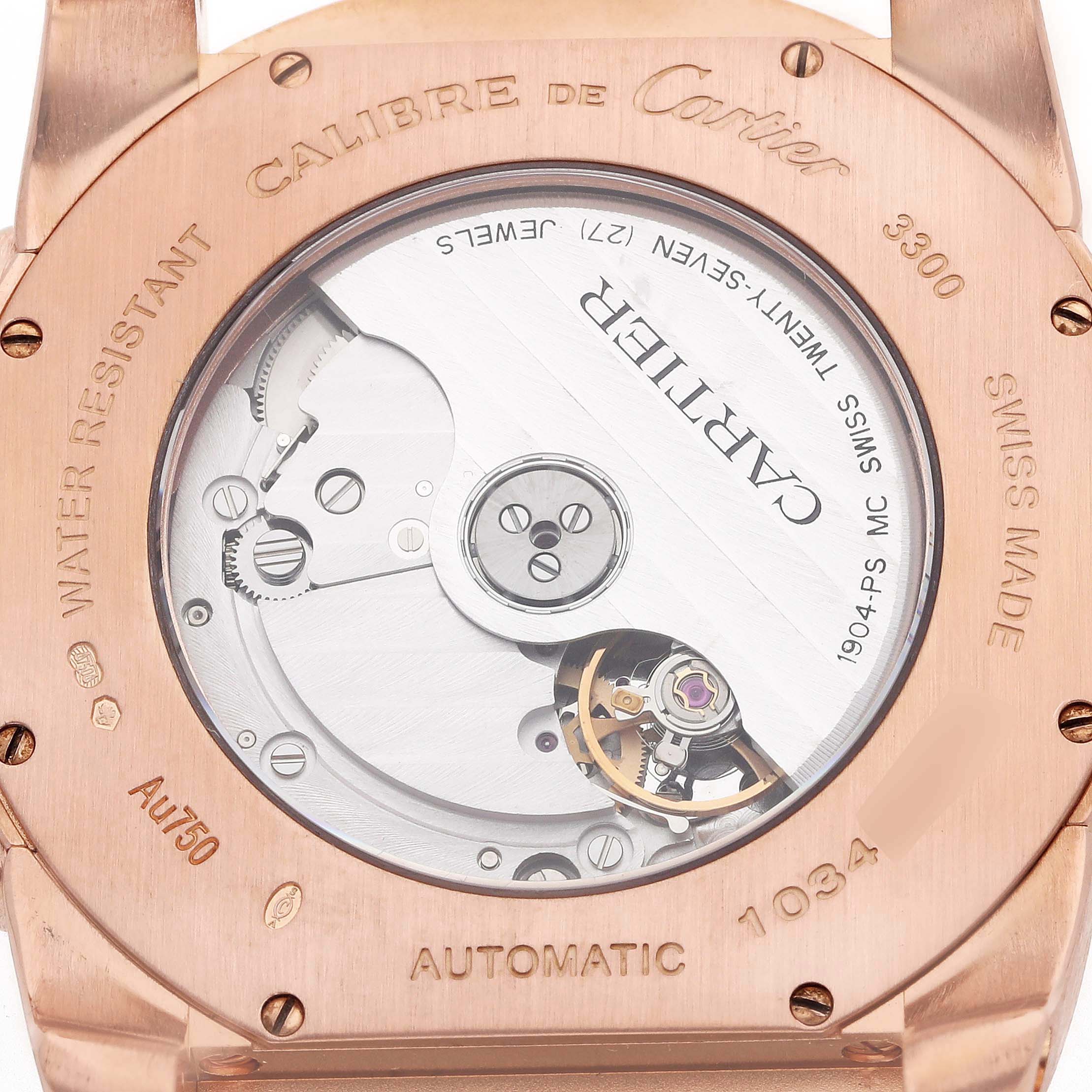 The image shows the back of a Calibre de Cartier watch, highlighting its automatic movement and detailed engravings.